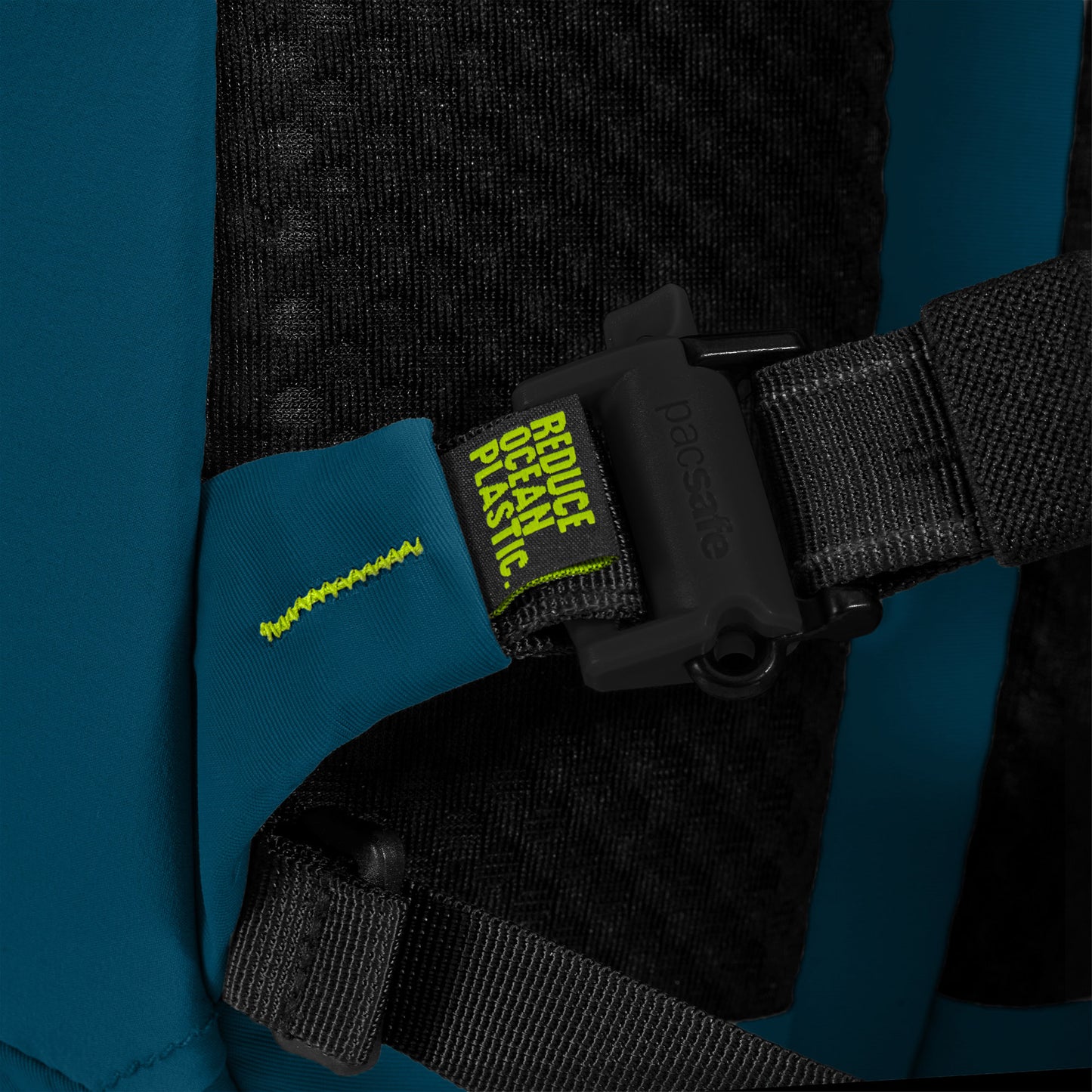 Close-up of Pacsafe ECO 18L strap with "Reduce Ocean Plastic" tag, featuring yellow text on green.