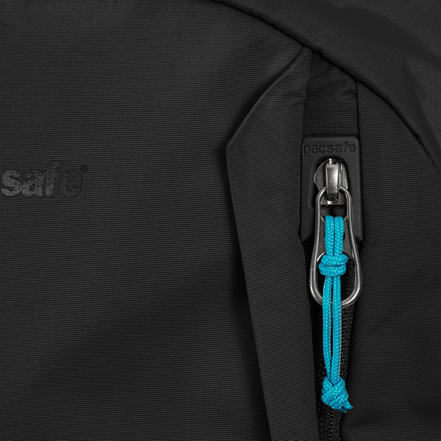 Close-up of Pacsafe ECO 25L's black zipper with blue pull cord, textured pattern, made from recycled materials.