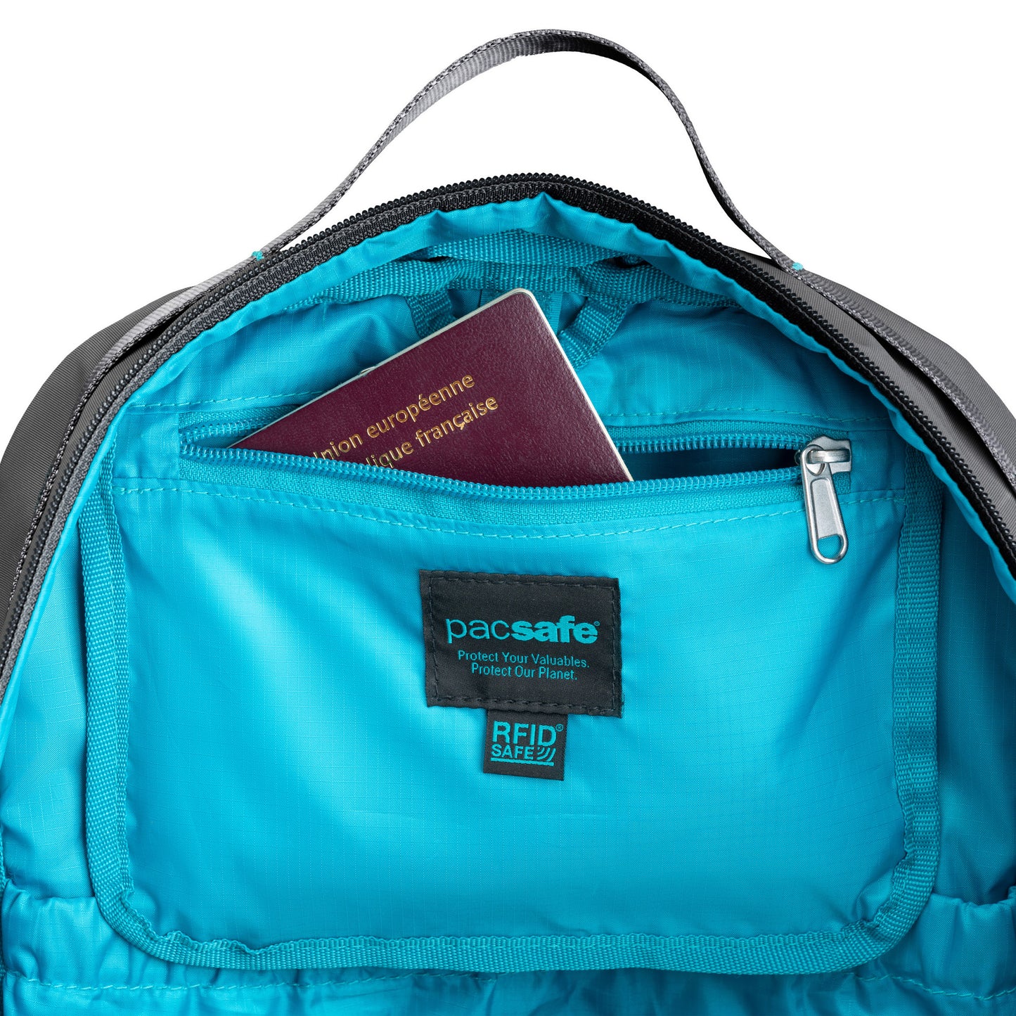 Open Pacsafe® ECO 25L backpack reveals blue interior with passport in a zip pocket.