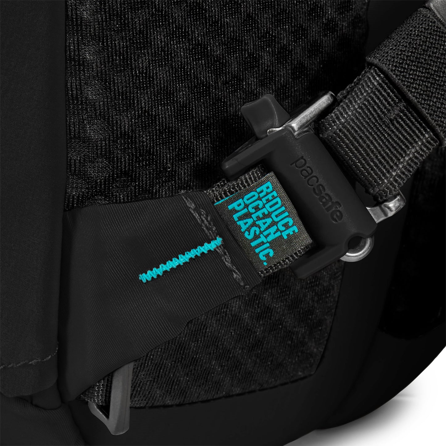 Close-up of a Pacsafe ECO 25L Anti-theft Backpack strap, highlighting stitching and "Reduce Ocean Plastic" label.