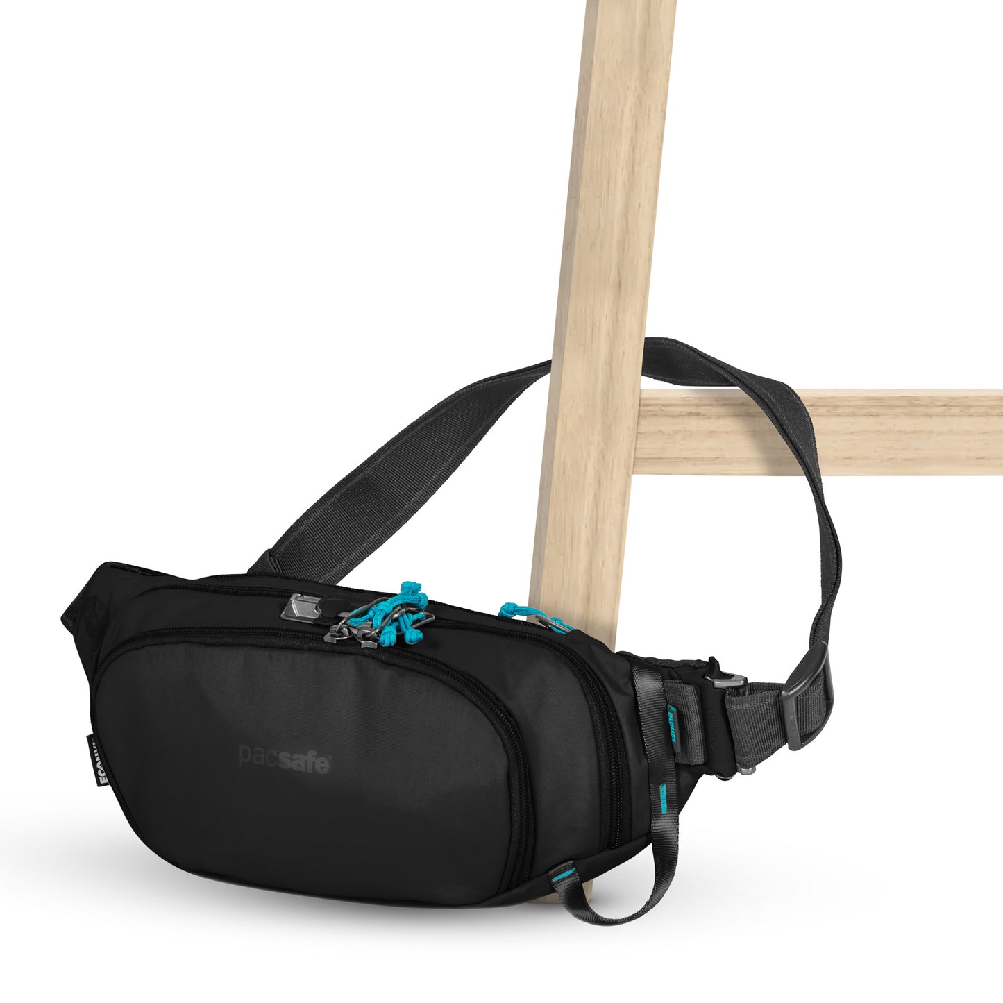 Pacsafe® ECO Anti-Theft Waist Pack with blue zippers on a wooden chair, crafted from recycled materials.