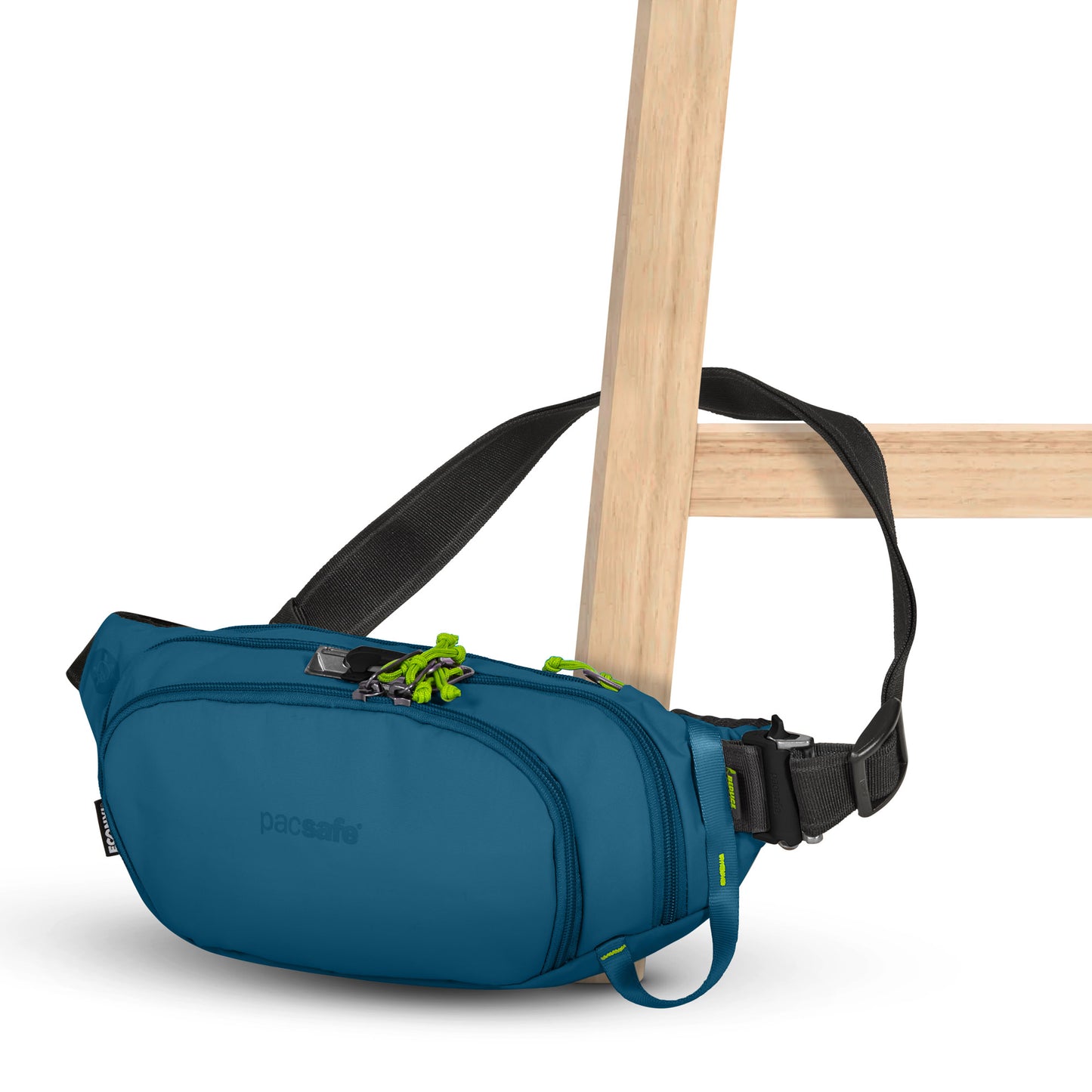 The Pacsafe® ECO Anti-Theft Waist Pack, with black strap and green zippers, hangs on a wooden chair.