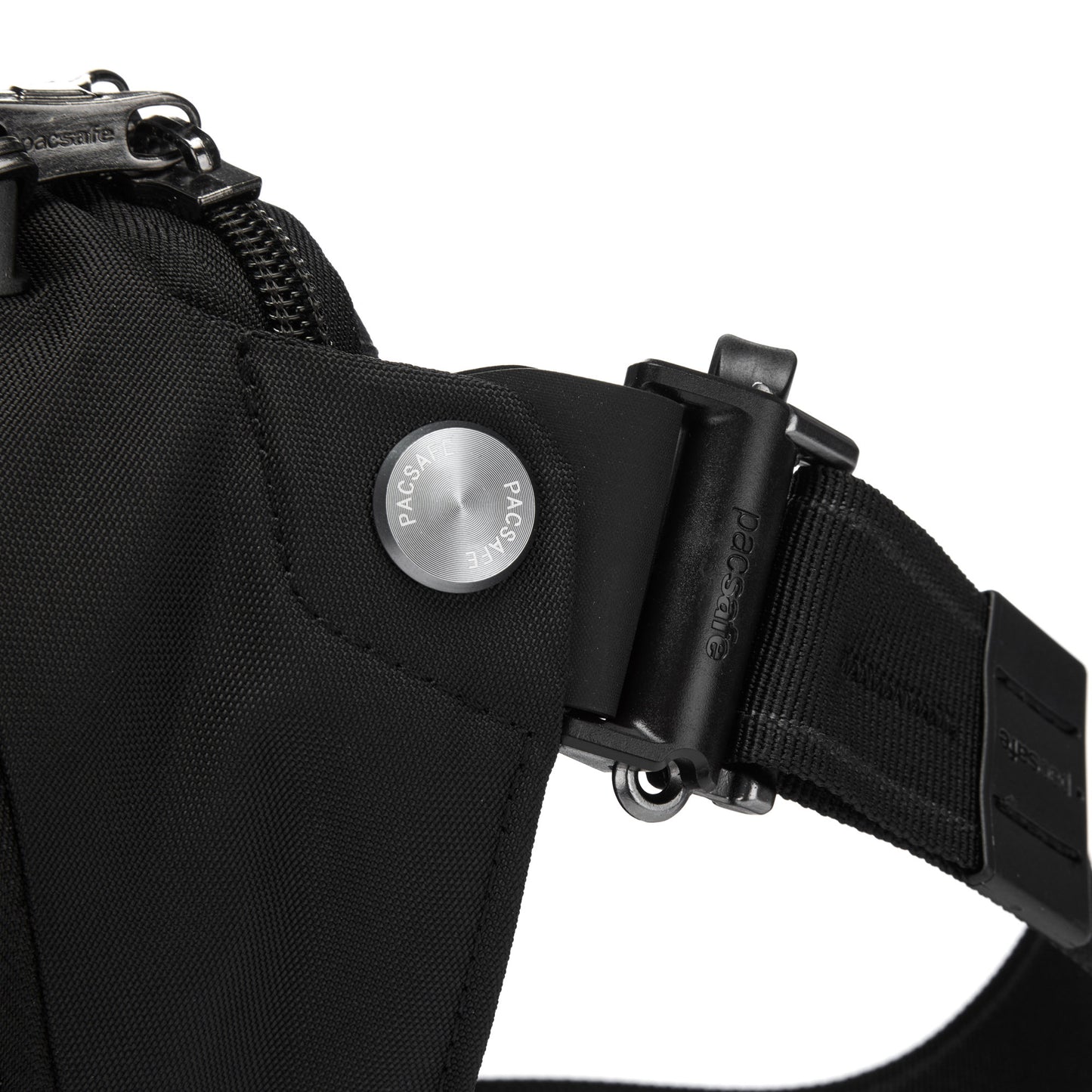 Close-up of black Pacsafe® EXP 12 Anti-theft Sling Crossbody with a metallic button and adjustable strap.