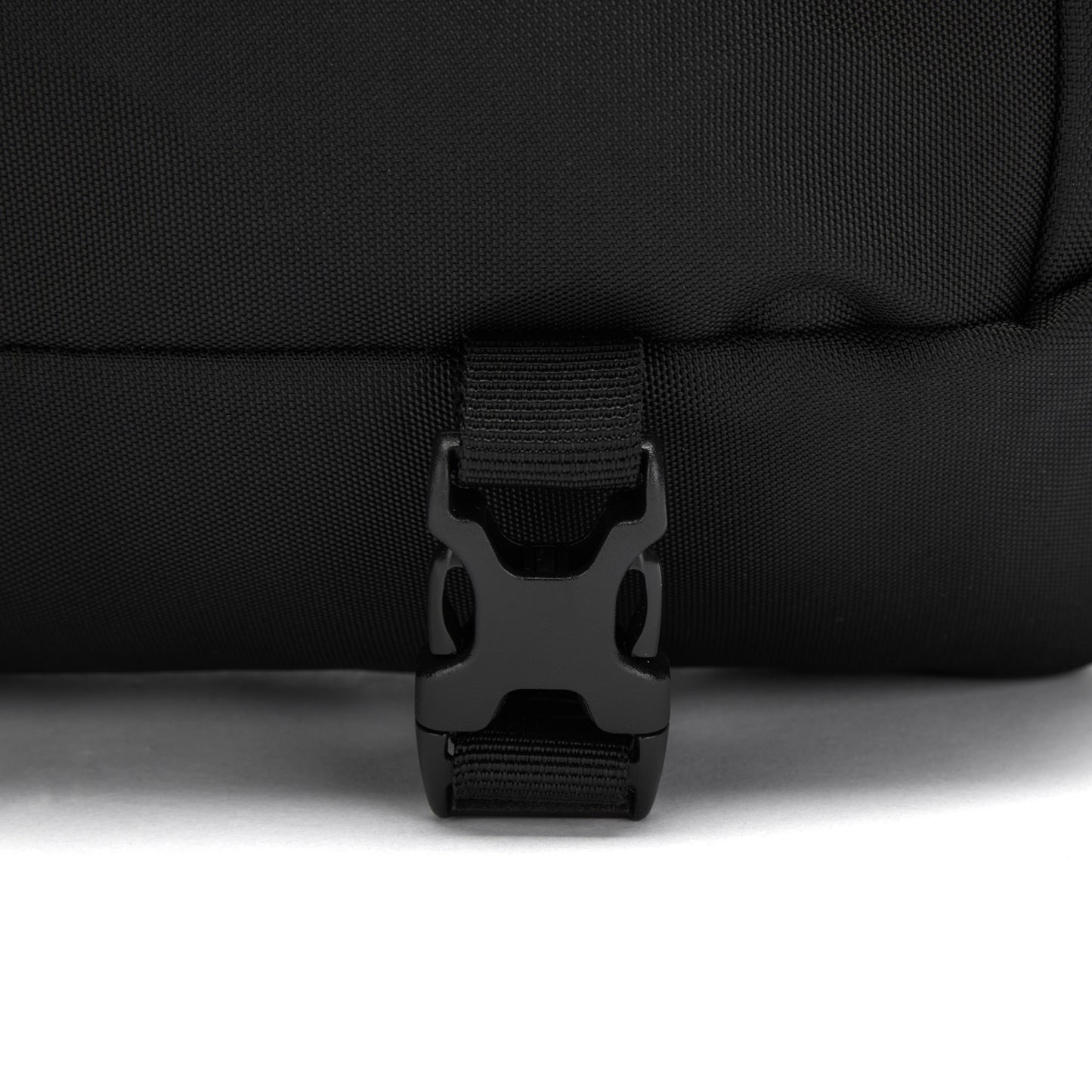 Zoom in on Pacsafe® EXP 12's black buckle fastened on the recycled polyester strap.