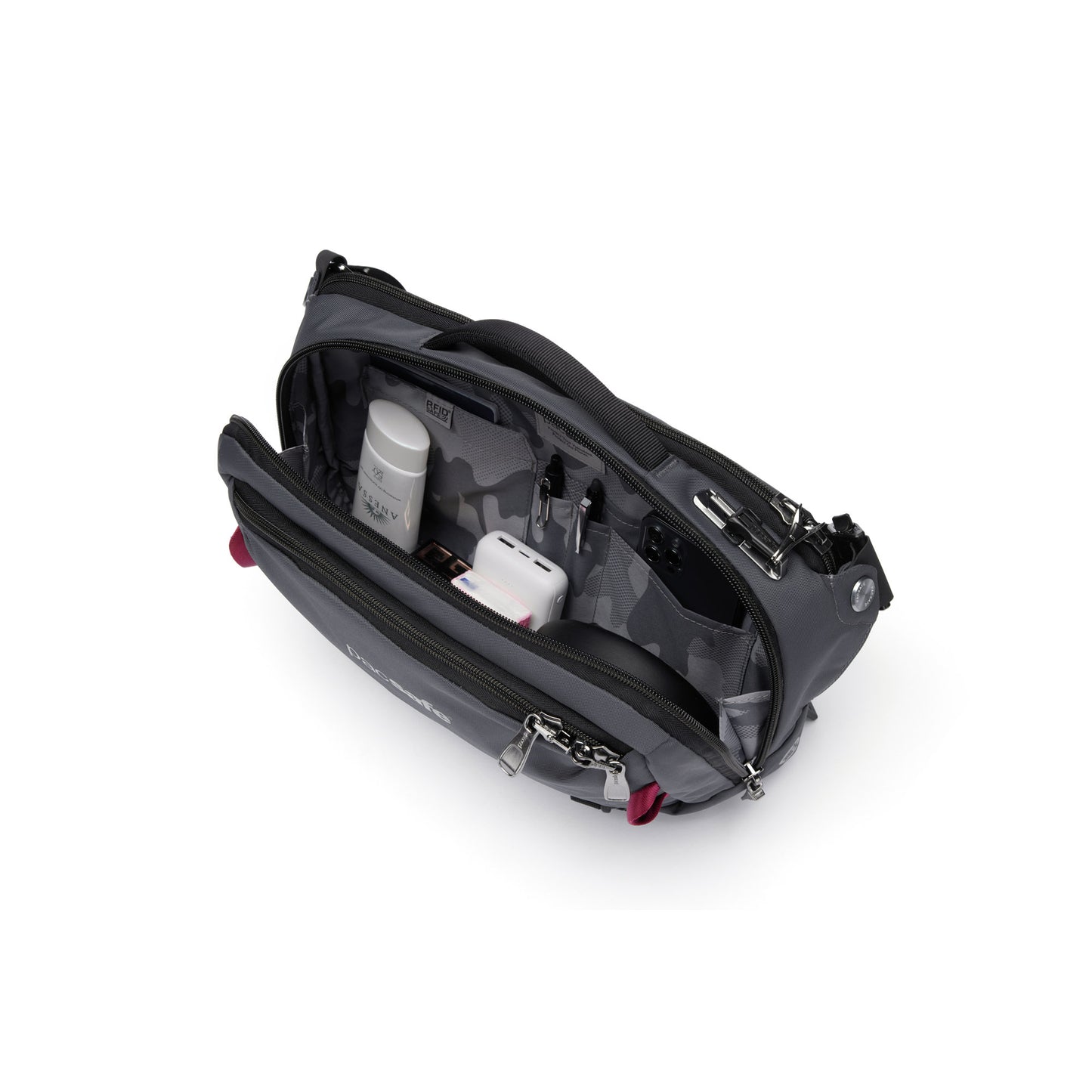 Interior view of slate Pacsafe® EXP 12 Anti-theft Sling Crossbody with charger, phone, pens, small bottle and other accessories inside