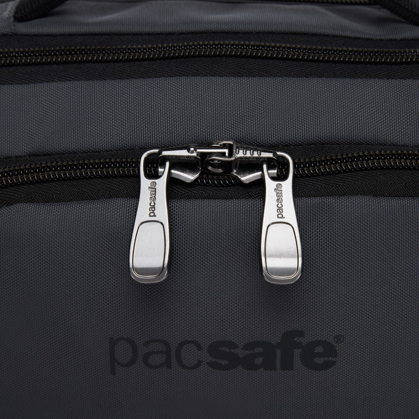 Close up of sliver zipper pulls on front pocket of slate Pacsafe® EXP 12 Anti-theft Sling Crossbody