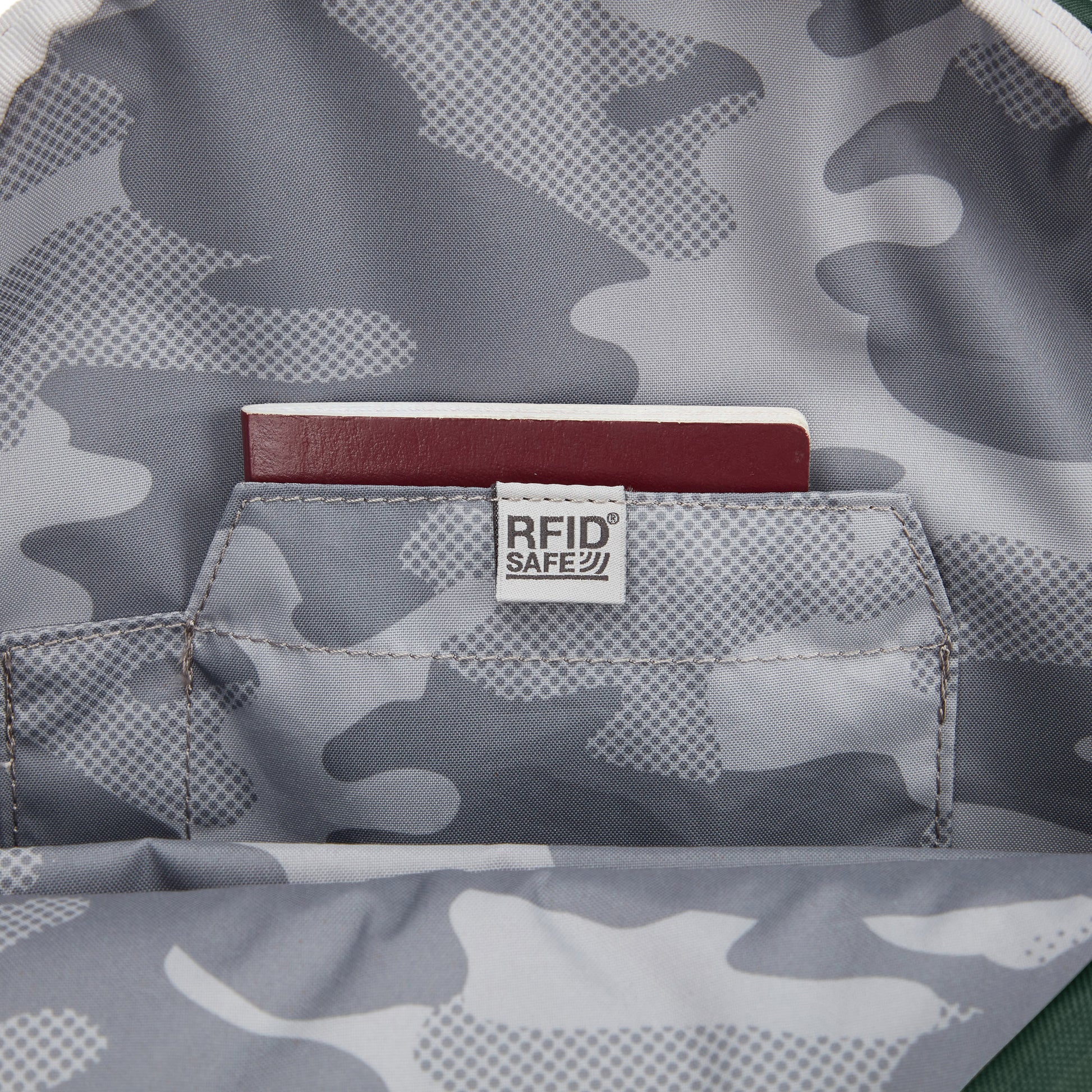 Close up of a passport inside the RFID safe pocket on inside lining of backpack