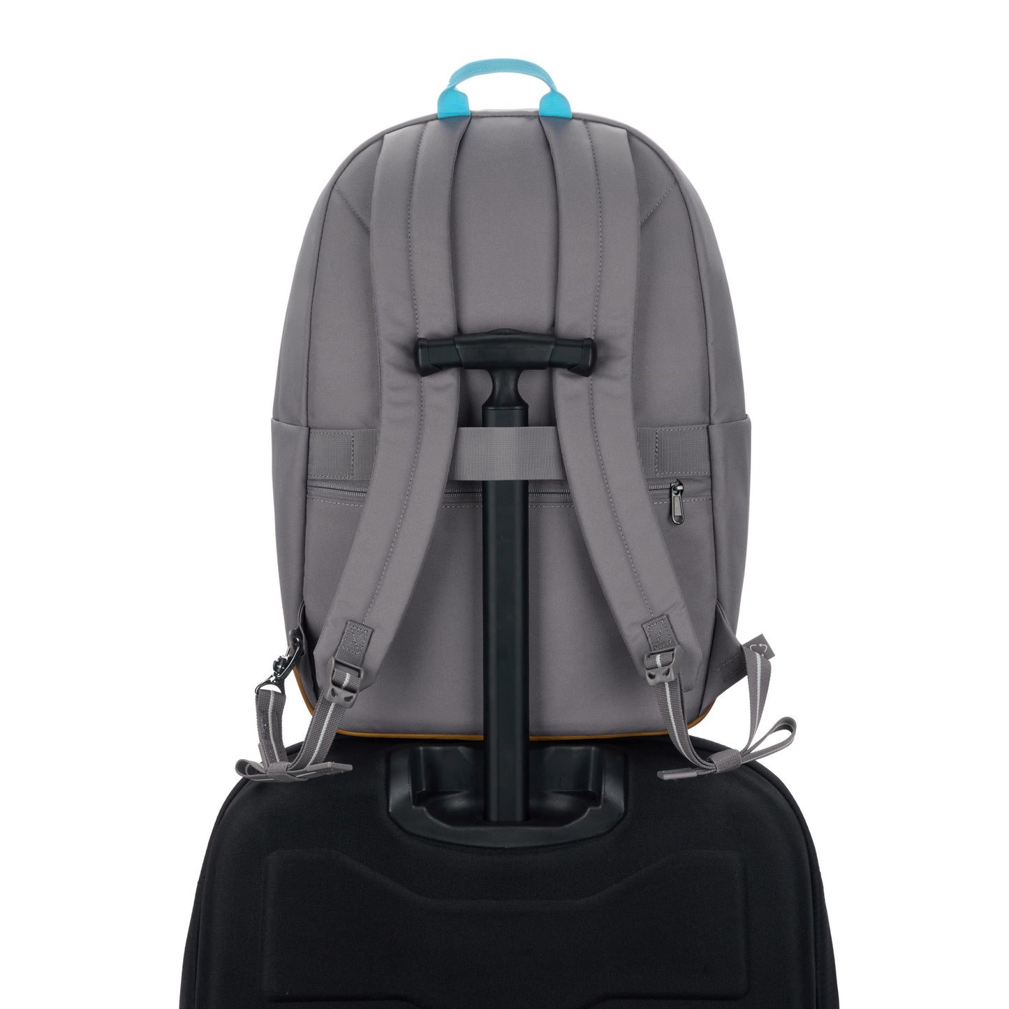 Pacsafe® GO 25L Anti-theft Backpack, stone, on top of a luggage with handle through the back luggage strap