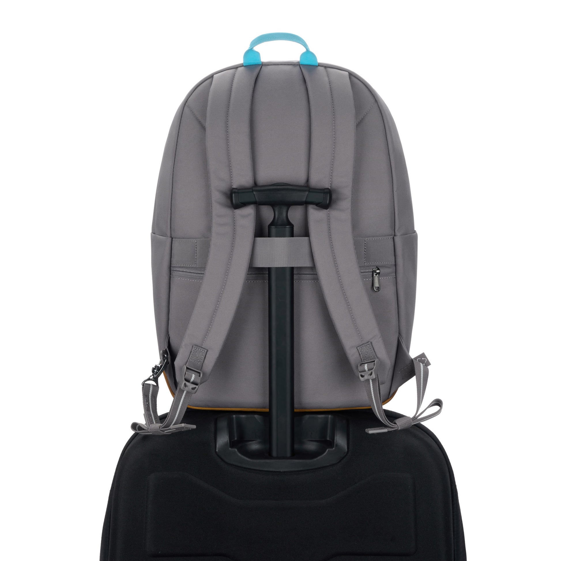 Pacsafe® GO 25L Anti-theft Backpack, stone, on top of a luggage with handle through the back luggage strap
