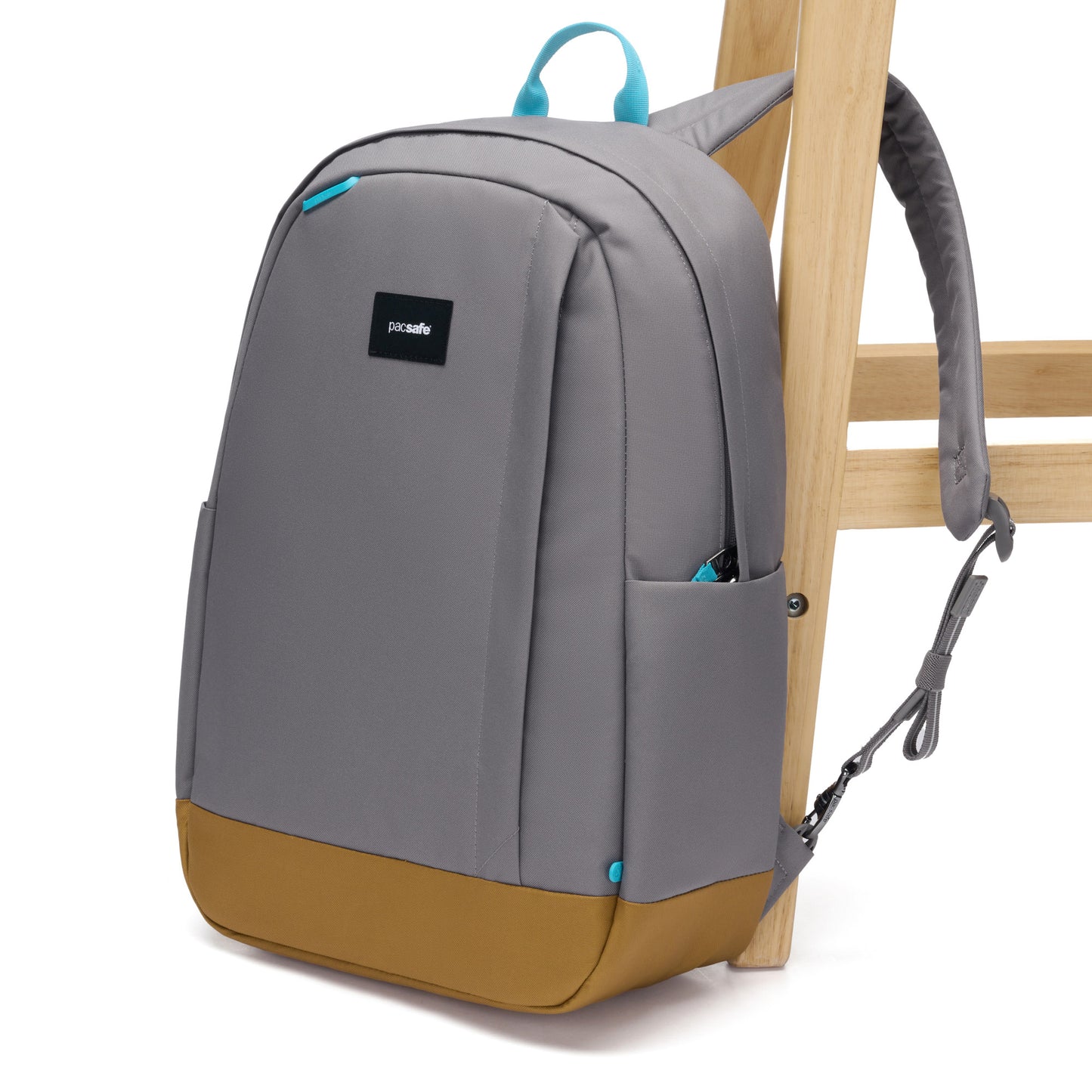 Pacsafe® GO 25L Anti-theft Backpack, stone, attached to a wooden chair leg.