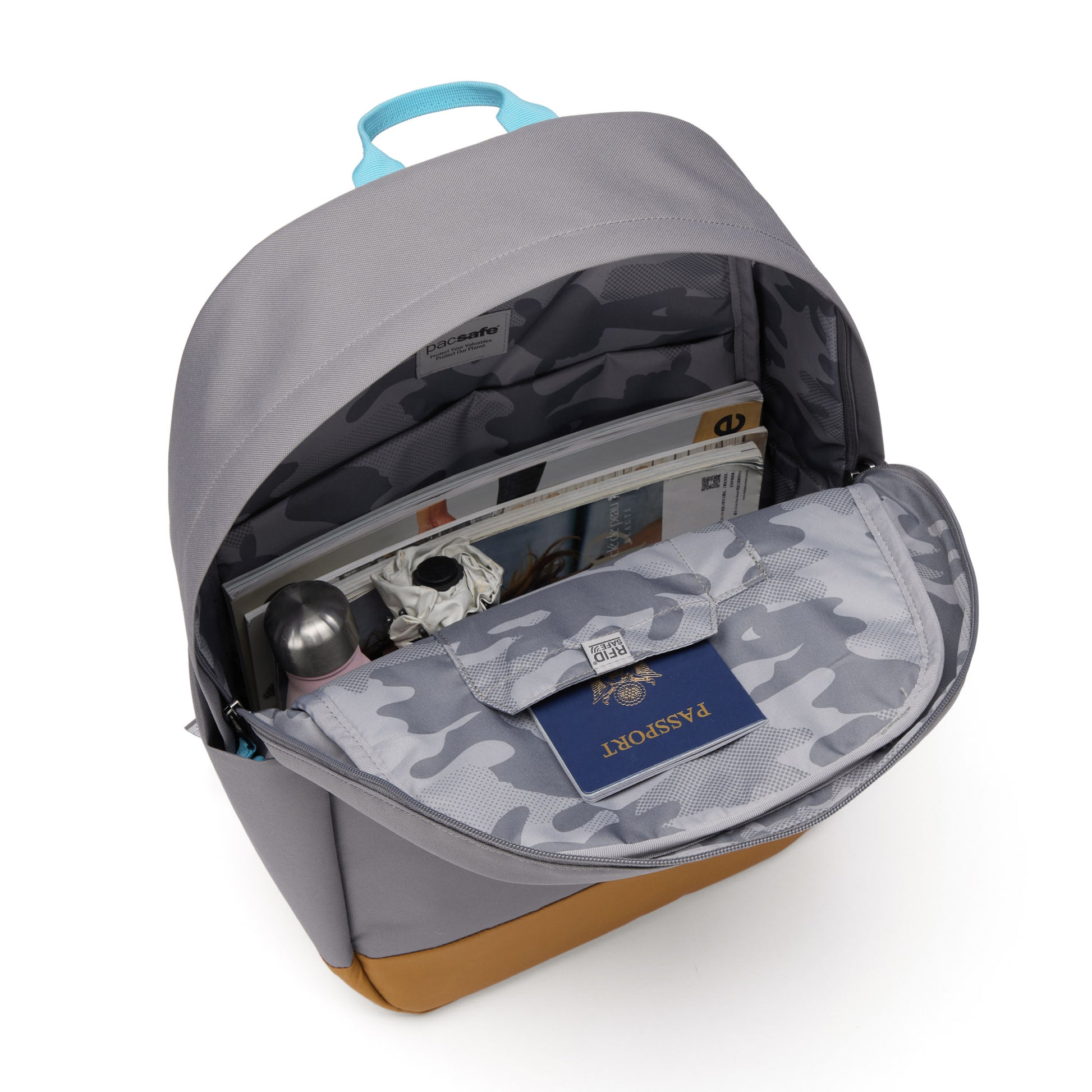 Pacsafe® GO 25L Anti-theft Backpack, stone, inside view with a water bottle, umbrella, books, and passport in the RFID pocket.
