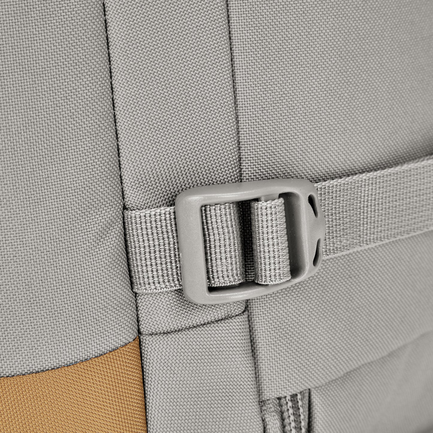 Close-up of a grey fabric strap with a plastic buckle on the Pacsafe® GO 34L Anti-theft Carry-on Backpack.