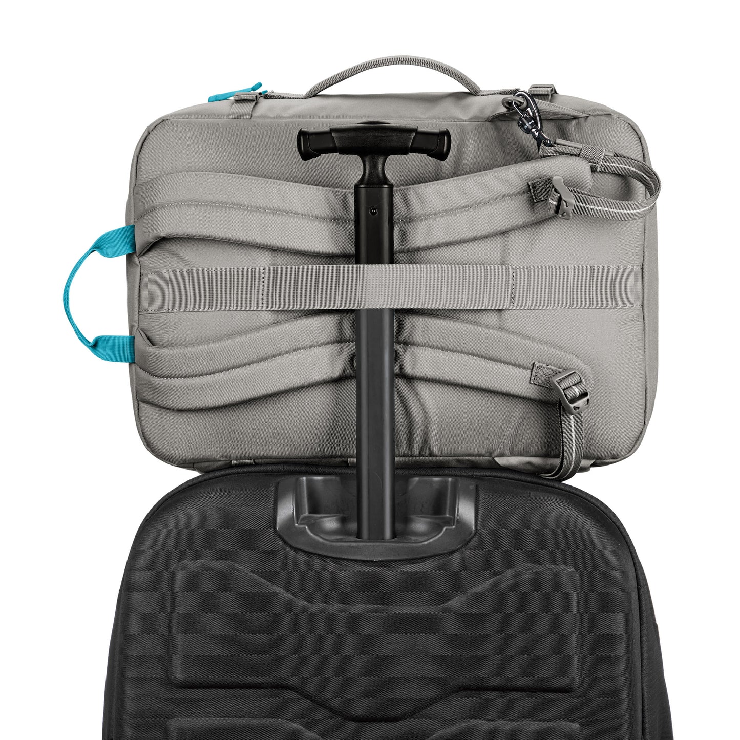 A Pacsafe GO 34L Anti-theft Carry-on Backpack rests on a black suitcase with telescopic handle.