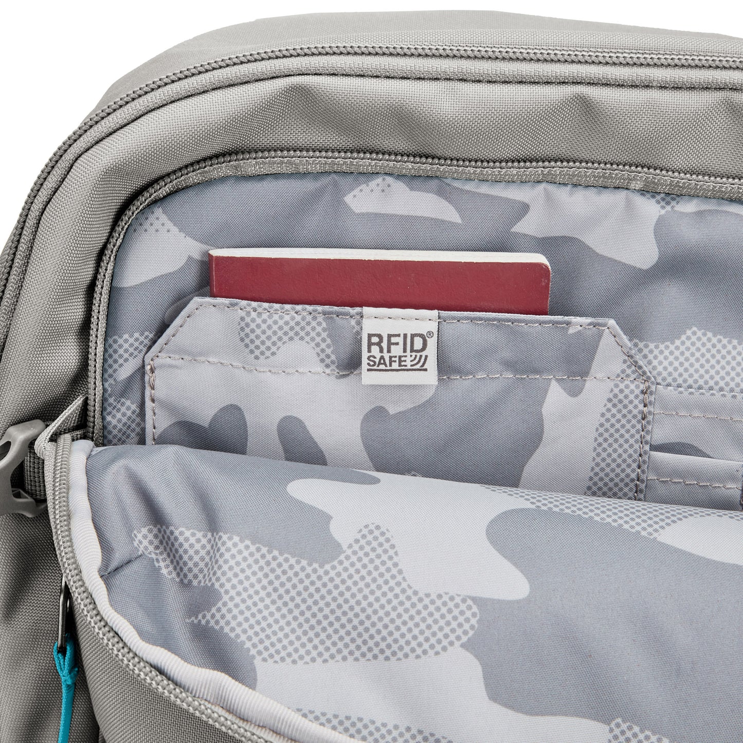 A maroon passport rests in an RFID-safe pocket inside the Pacsafe® GO 34L Anti-theft Carry-on Backpack.