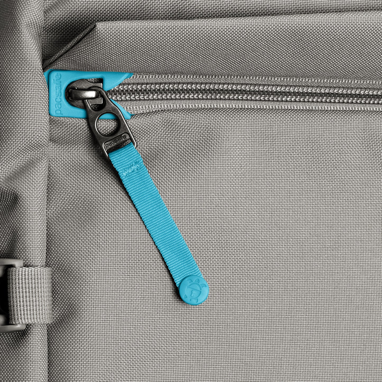 Close-up of the Pacsafe® GO 44L Anti-theft Carry-on Backpack with zipper, blue pull tab, and recycled polyester detail.