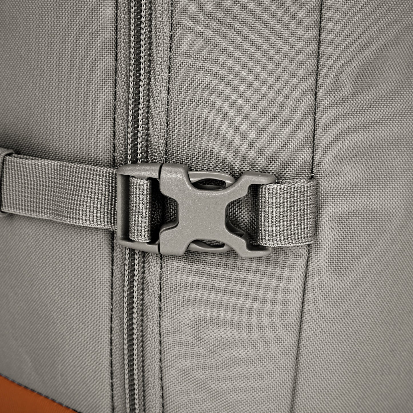 Close-up of Pacsafe® GO 44L Anti-theft Carry-on Backpack’s gray buckle, zipper, strap, and RFID-blocking pocket.
