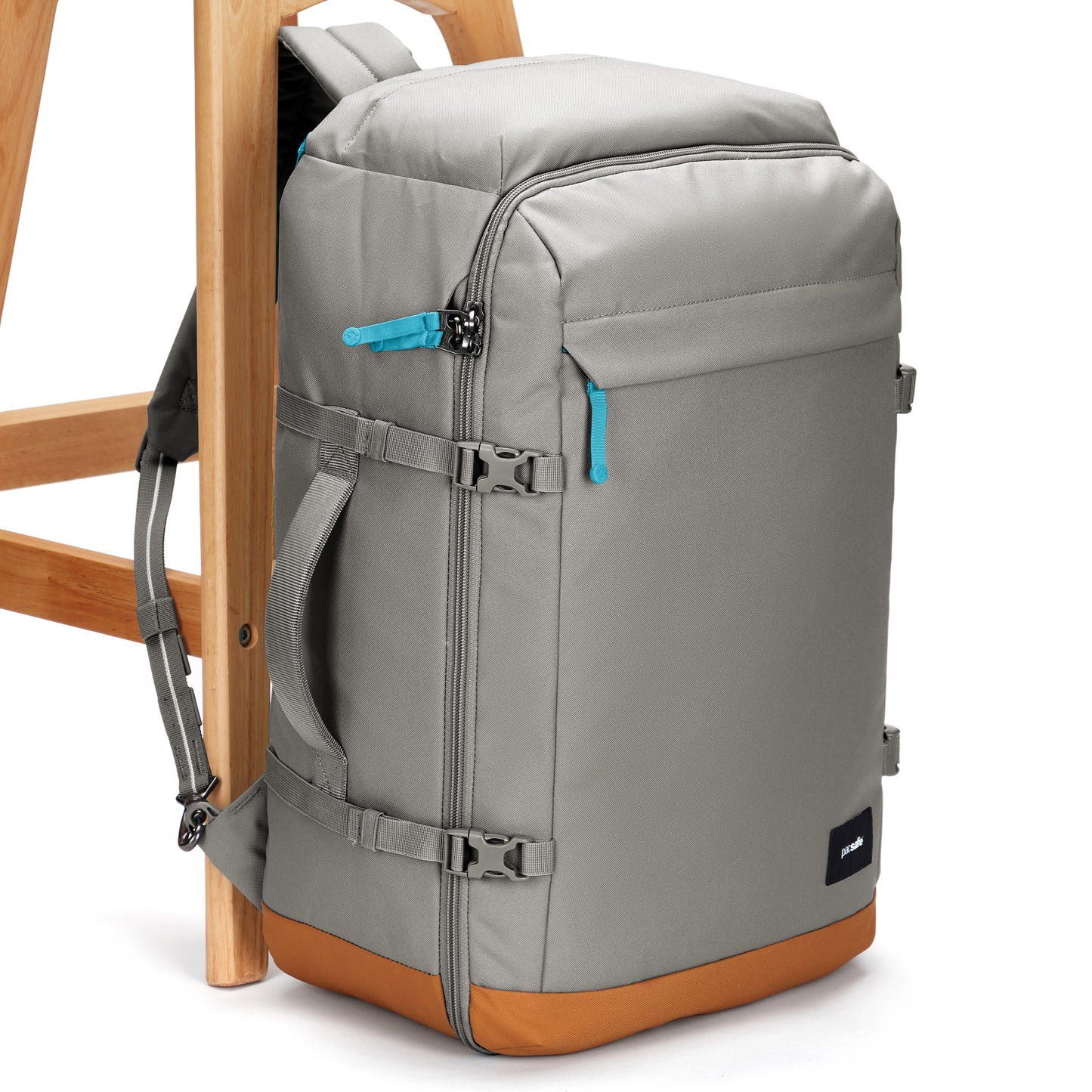 Pacsafe® GO 44L Anti-theft Carry-on Backpack, recycled polyester, blue zippers, brown base on a wooden chair.