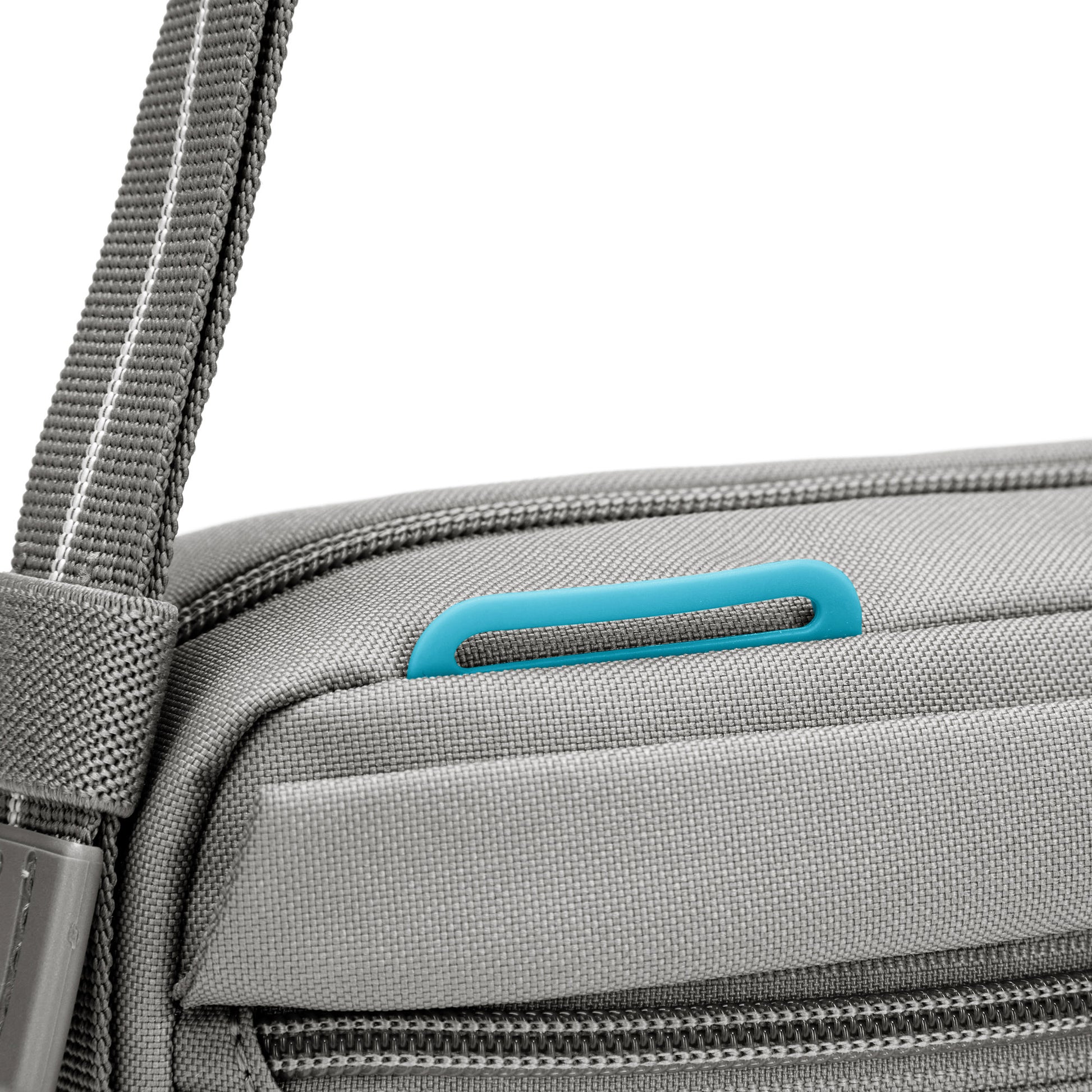 Close up of turquoise lashing point on top front of stone Pacsafe® GO Anti-Theft Crossbody Bag