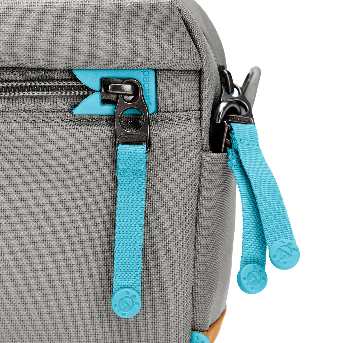 Close up of turquoise zipper pulls and lockable zippers on the stone Pacsafe® GO Anti-Theft Crossbody Bag