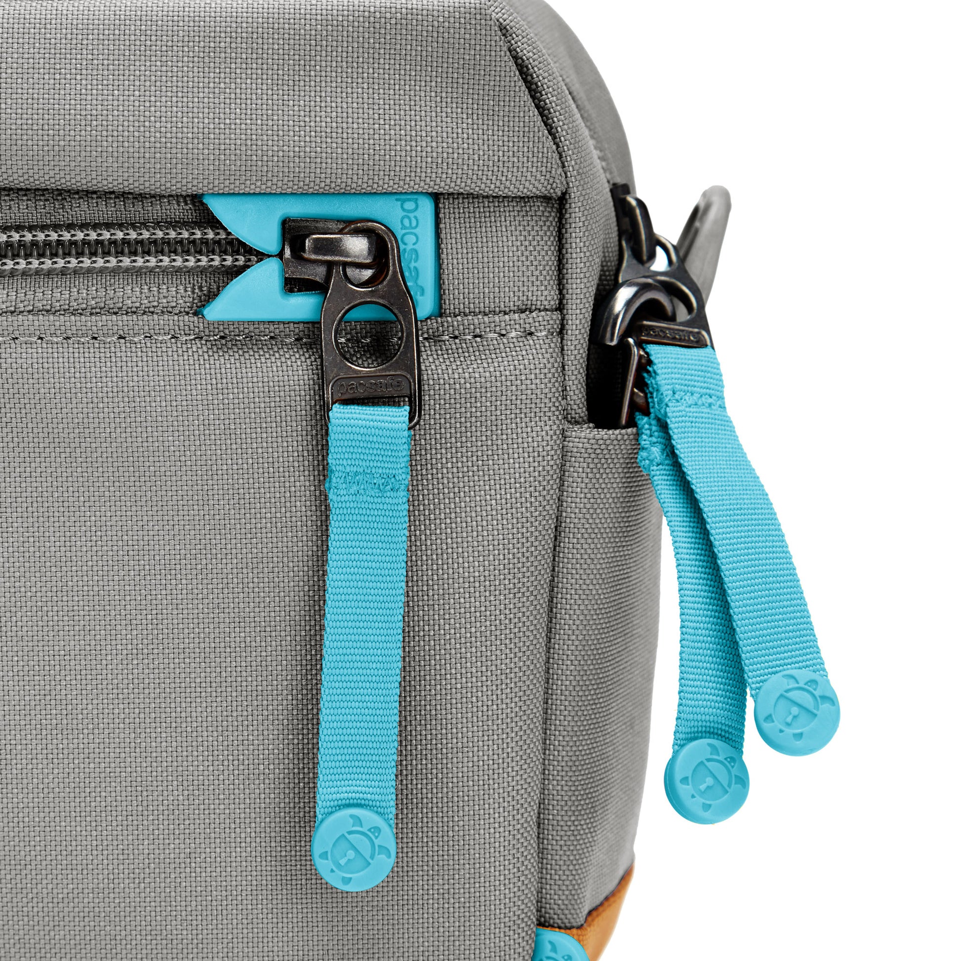 Close up of turquoise zipper pulls and lockable zippers on the stone Pacsafe® GO Anti-Theft Crossbody Bag