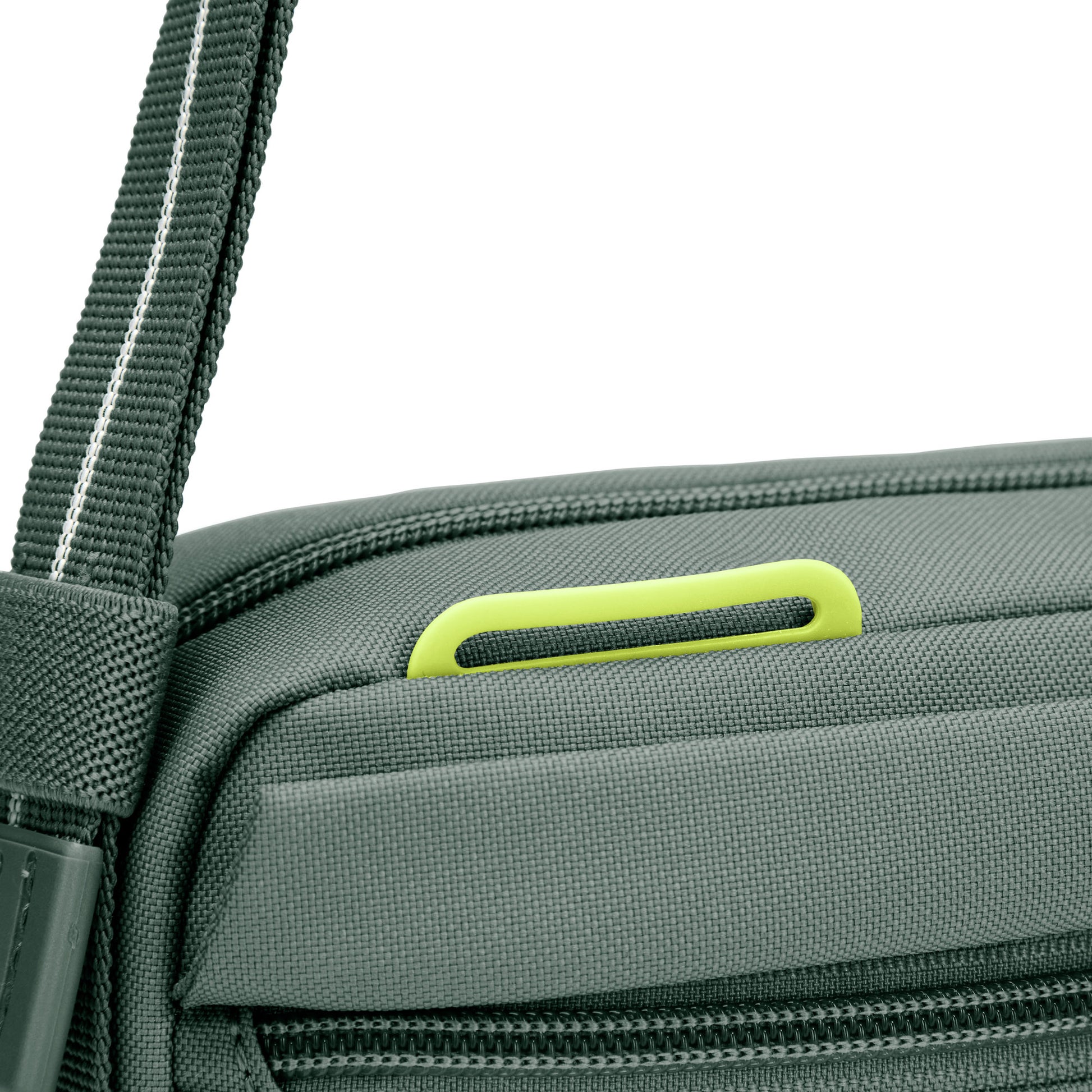 Close up of lime green lashing point on top front of spruce green Pacsafe® GO Anti-Theft Crossbody Bag