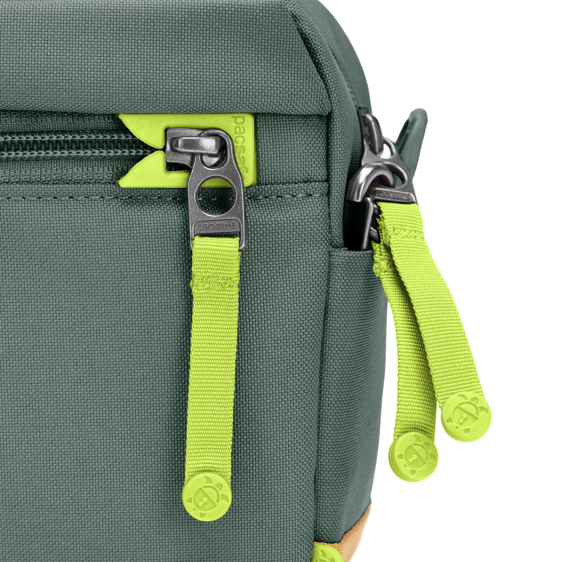 Close up of lime green zipper pulls and lockable zippers on the spruce green Pacsafe® GO Anti-Theft Crossbody Bag