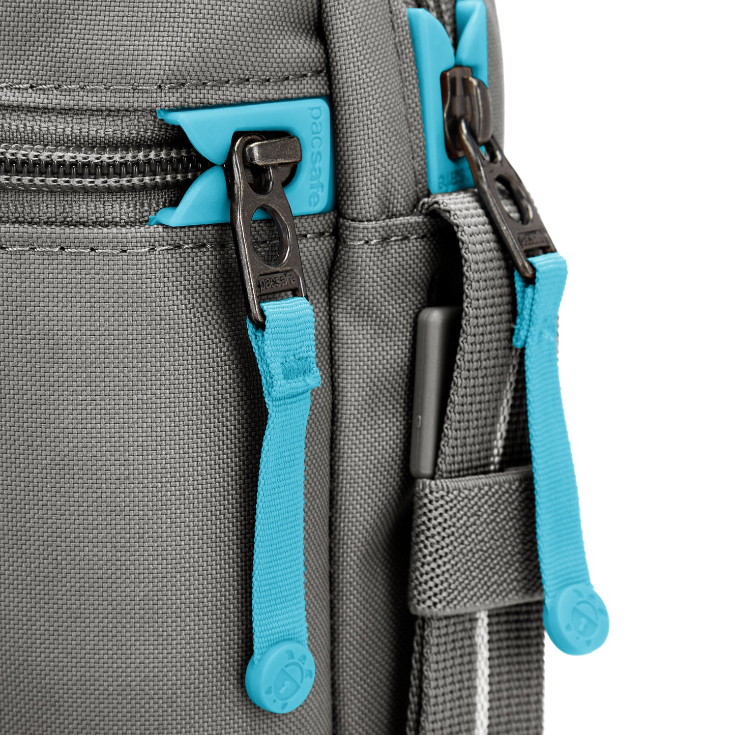 Close up of turquoise zipper pulls and lockable zippers on the stone Pacsafe® GO Anti-Theft Festival Crossbody