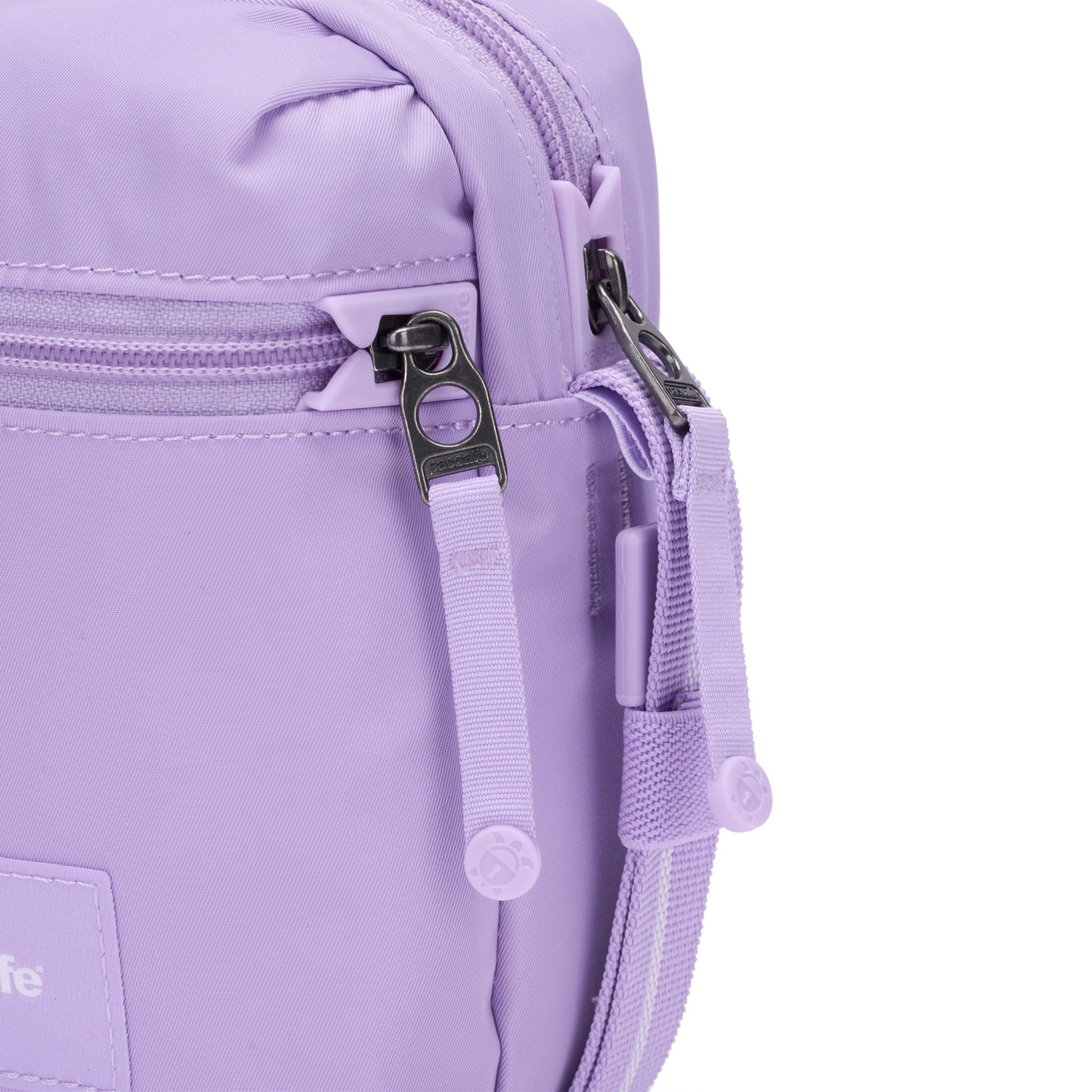 Close-up of the Pacsafe® GO Anti-Theft Micro Crossbody in lavender with dual zippers and fabric pull tabs.