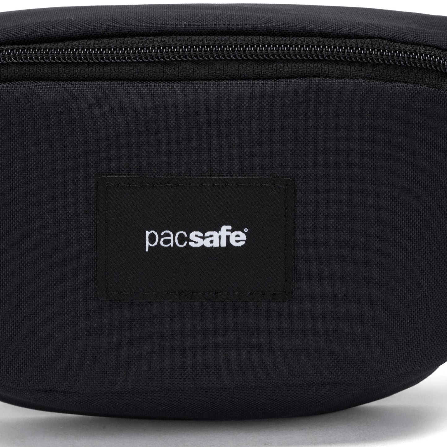 Close-up of the Pacsafe® GO Anti-Theft Micro Sling, black, with a visible Pacsafe logo on the front.