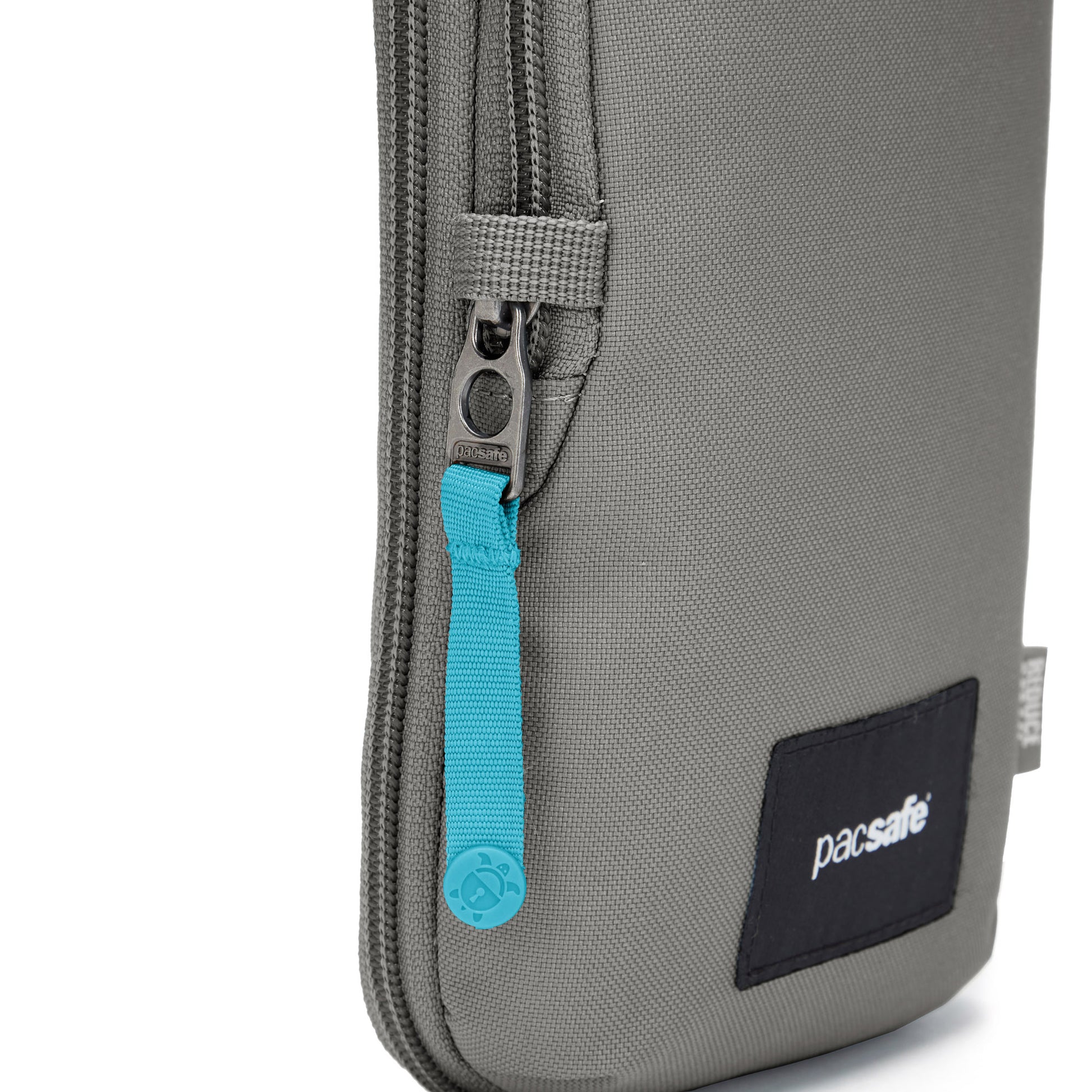 Close up of turquoise zipper pull and on stone Pacsafe® GO Anti-Theft Tech Crossbody