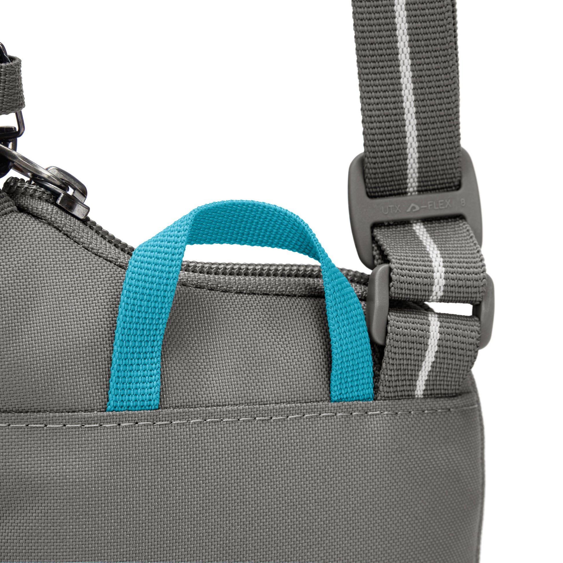 Close up of turquoise top loop on stone Pacsafe® GO Anti-Theft Tech Crossbody