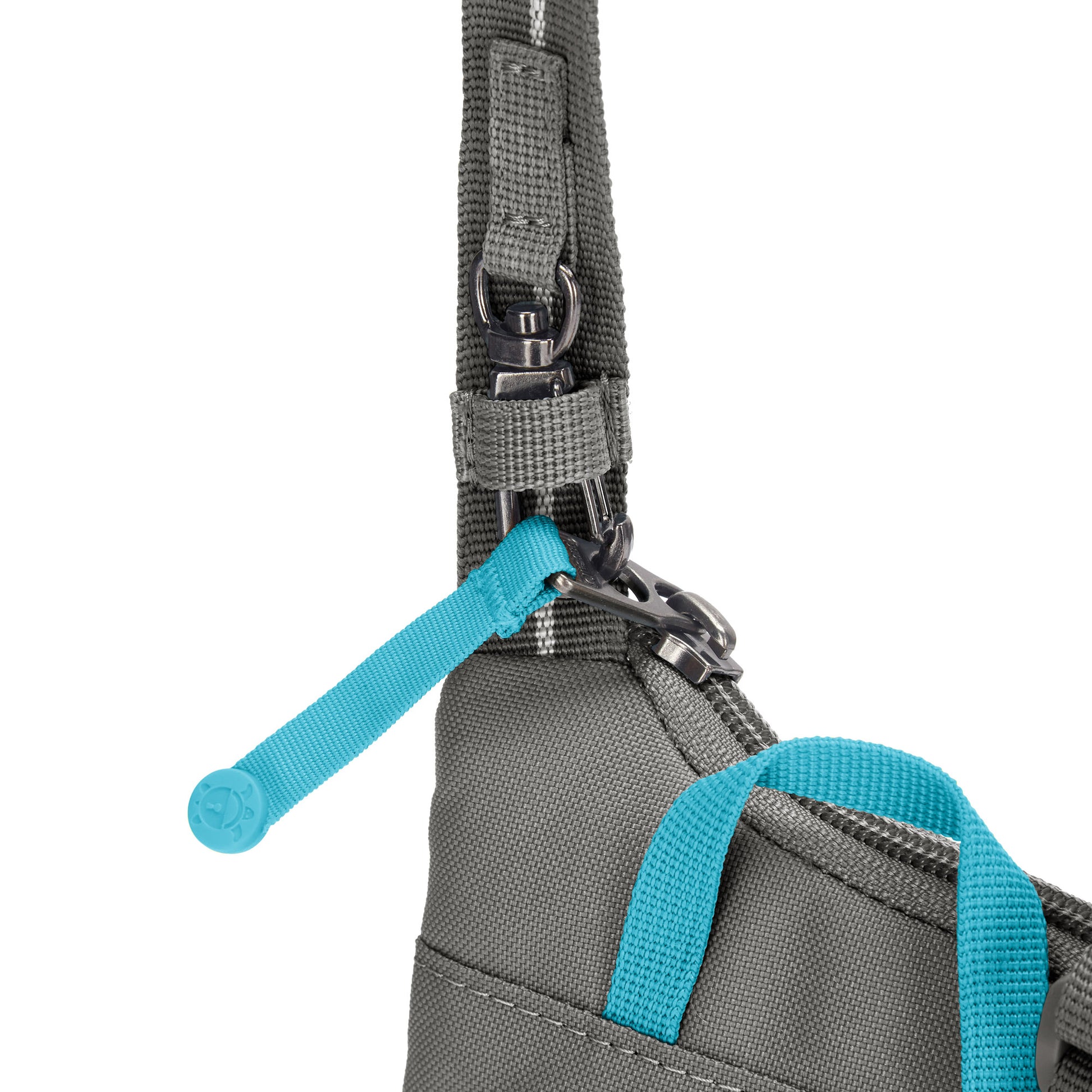 Close up of lockable zipper pull on stone Pacsafe® GO Anti-Theft Tech Crossbody