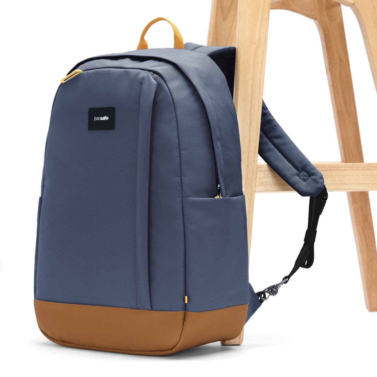 Pacsafe® GO 25L Anti-theft Backpack, coastal blue, attached to wooden chair leg.