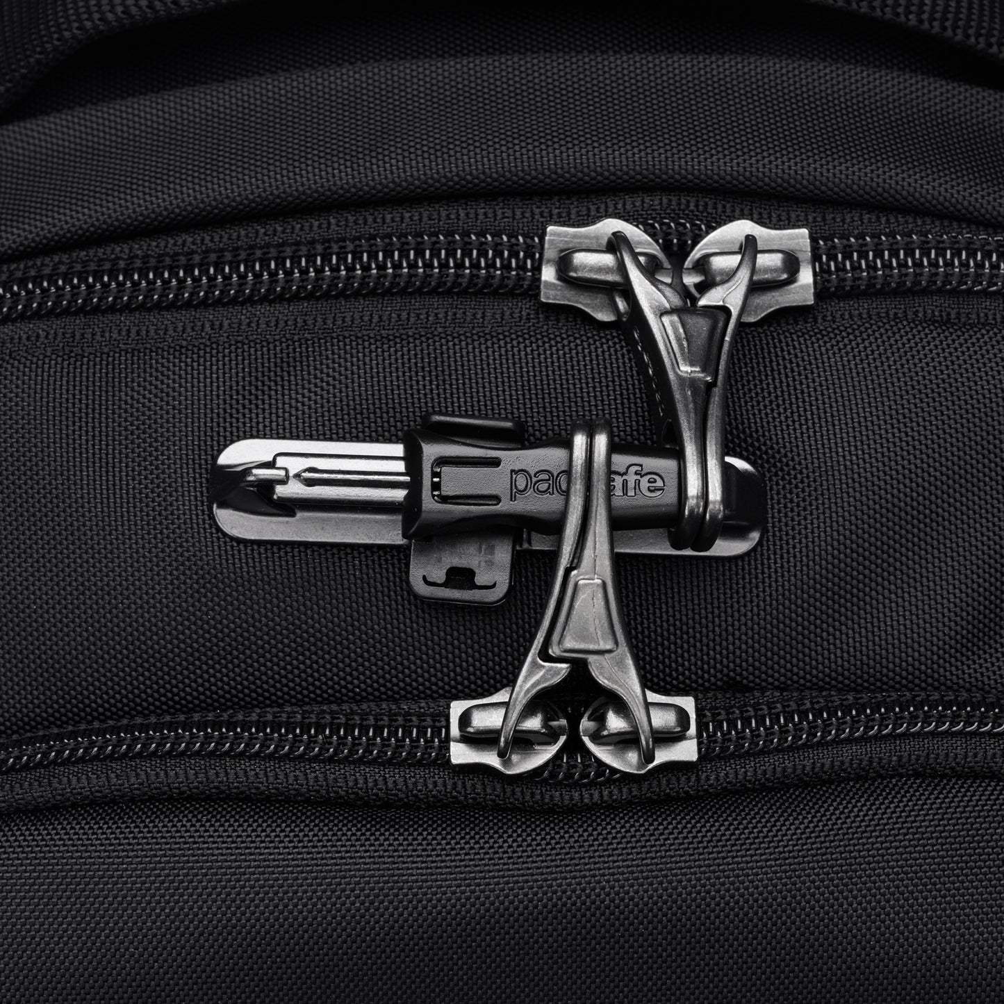 Close up of lockable zipper pulls on black Pacsafe V 16L All-Around Backpack.