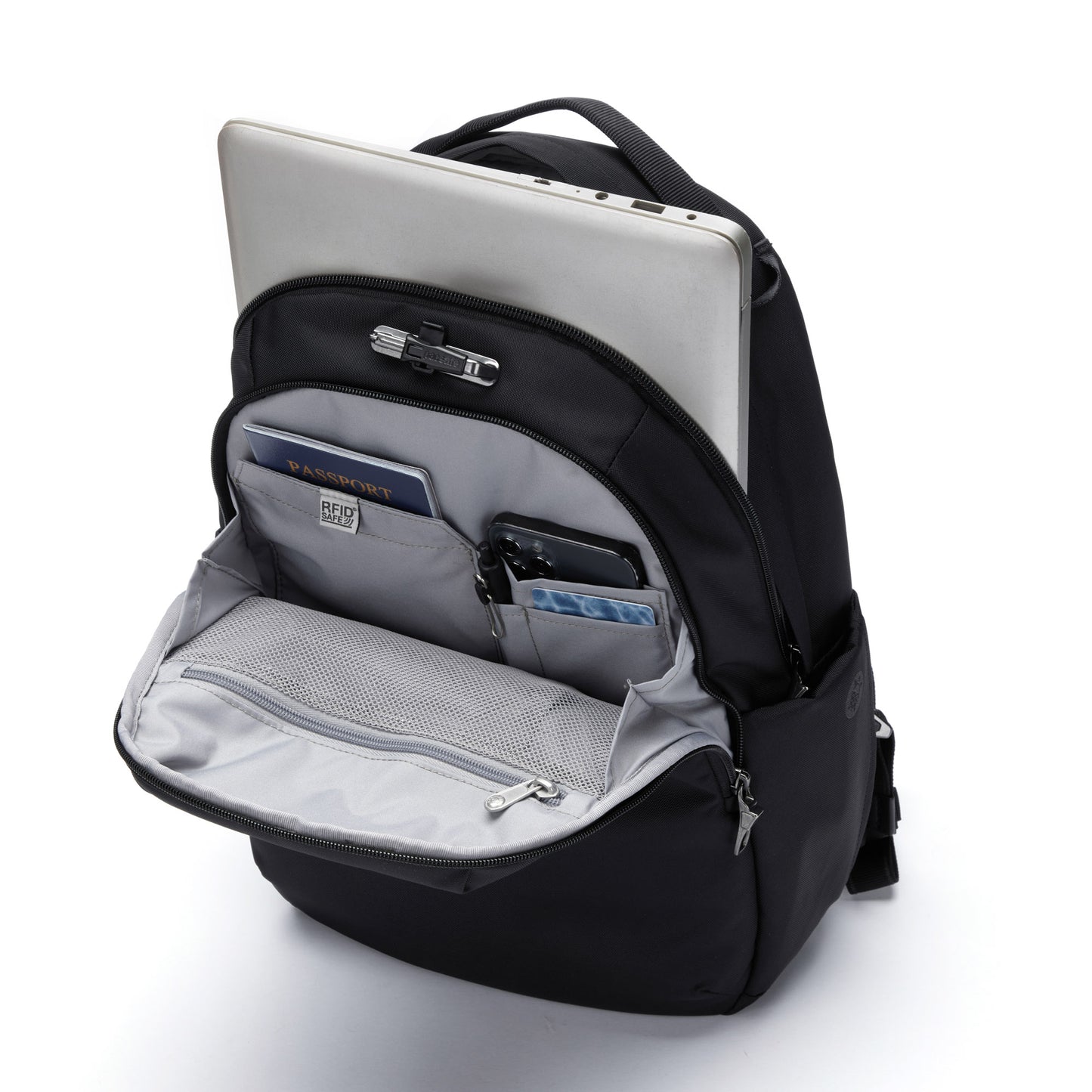 Open view of Pacsafe® V 16L anti-theft backpack in black packed with a laptop, passport, phone, pen and cards.