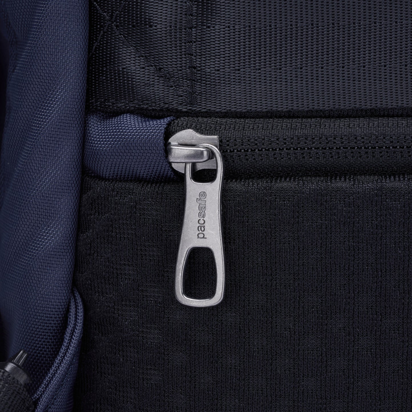 Close-up of a zipper pull on the back of the Pacsafe® V 16L Anti-theft Backpack.
