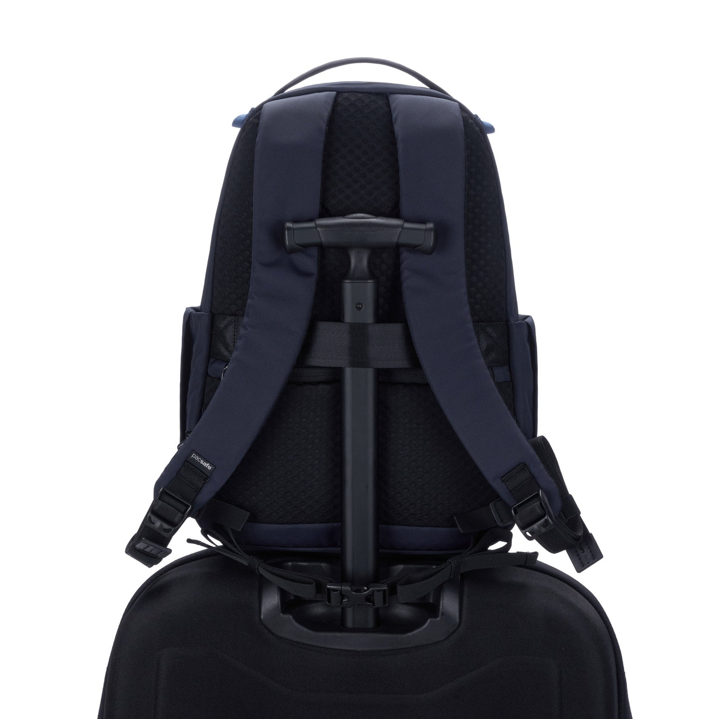 Pacsafe® V 16L backpack: ocean, back view with the handle for trolley attachment around a luggage.