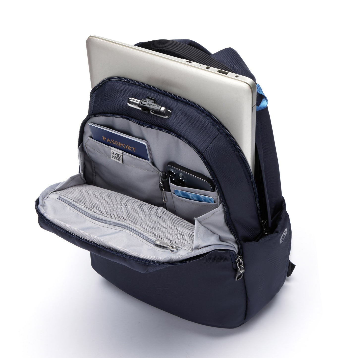 Open view of Pacsafe® V 16L anti-theft backpack in ocean packed with a laptop, passport, phone, pen and cards.