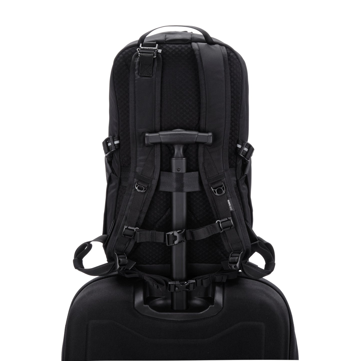 A Pacsafe V 24L black anti-theft backpack with laptop sleeve is attached to a trolley handle, viewed from the back.
