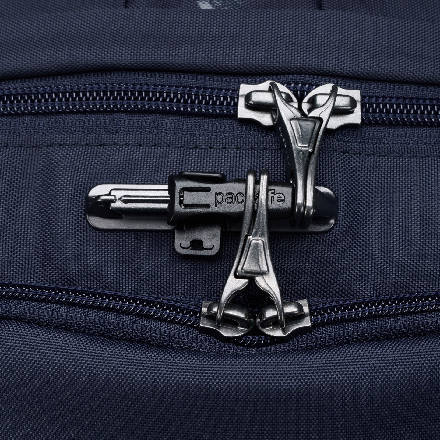 Close up of lockable zipper pulls on ocean blue Pacsafe® V 24L Anti-theft Active Backpack.