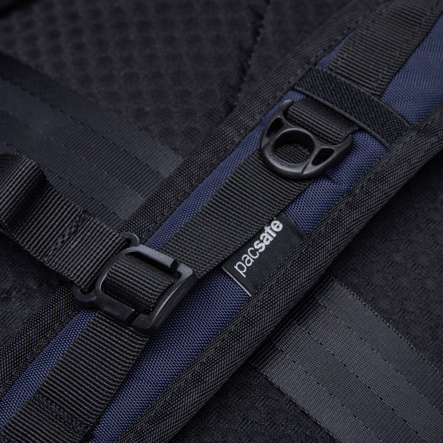 Close-up of one shoulder strap on the ocean blue Pacsafe® V 24L Anti-theft Active Backpack.