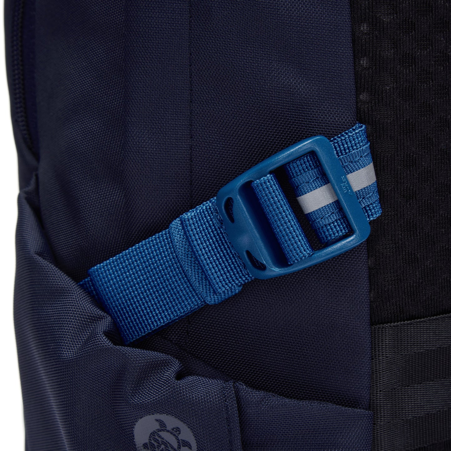 Close-up of a blue strap with a plastic buckle on the Pacsafe® V 24L Anti-theft Active Backpack.
