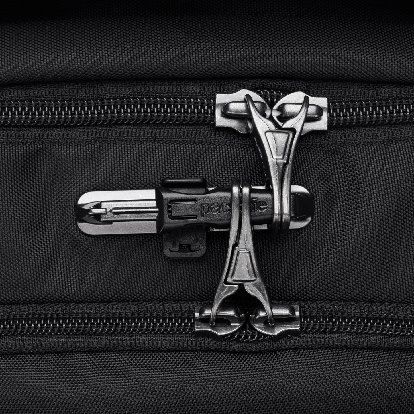 Close-up of interlocked zippers with a lock on the Pacsafe® V 26L Anti-theft Tour Backpack, ideal for travel essentials.