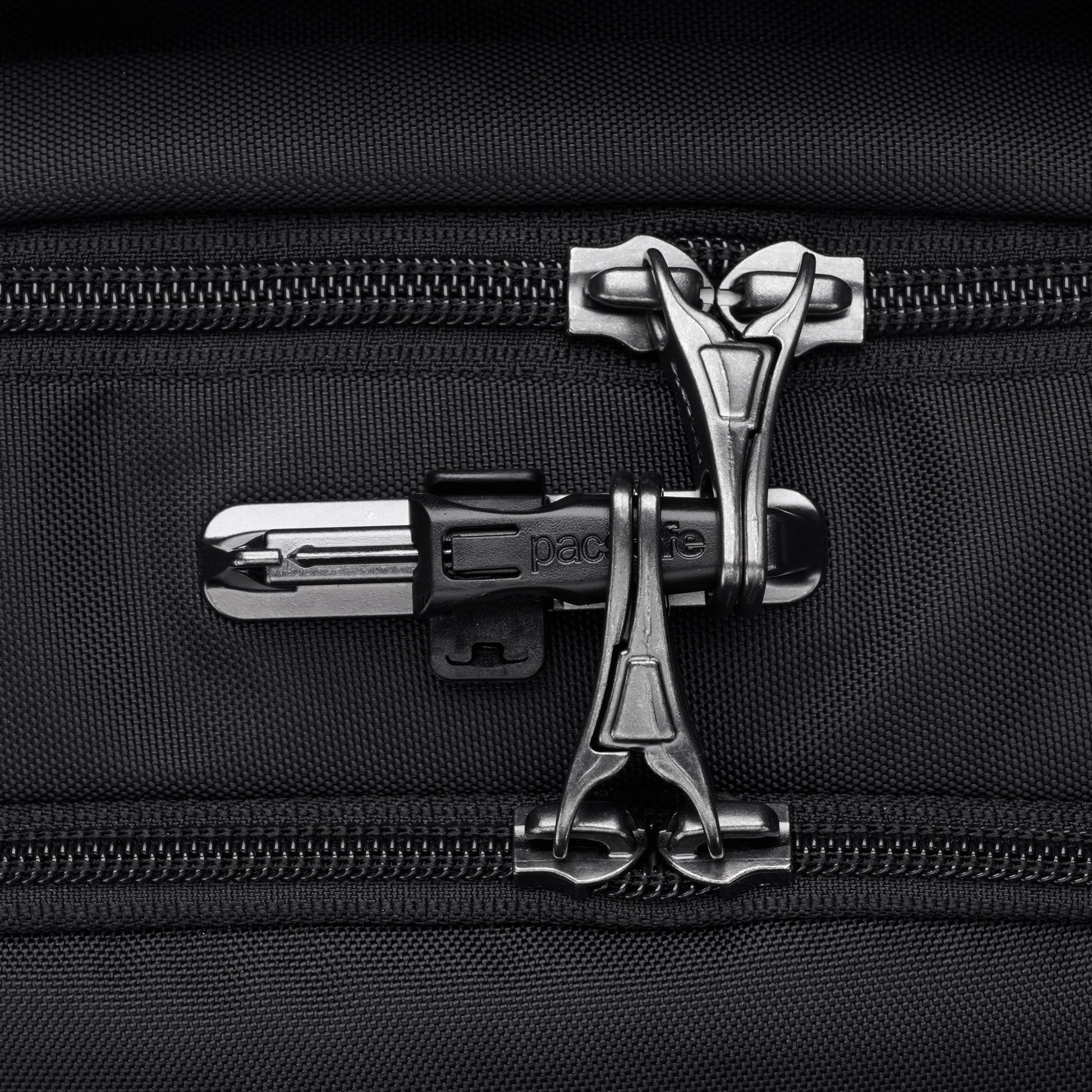 Close-up of interlocked zippers with a lock on the Pacsafe® V 26L Anti-theft Tour Backpack, ideal for travel essentials.