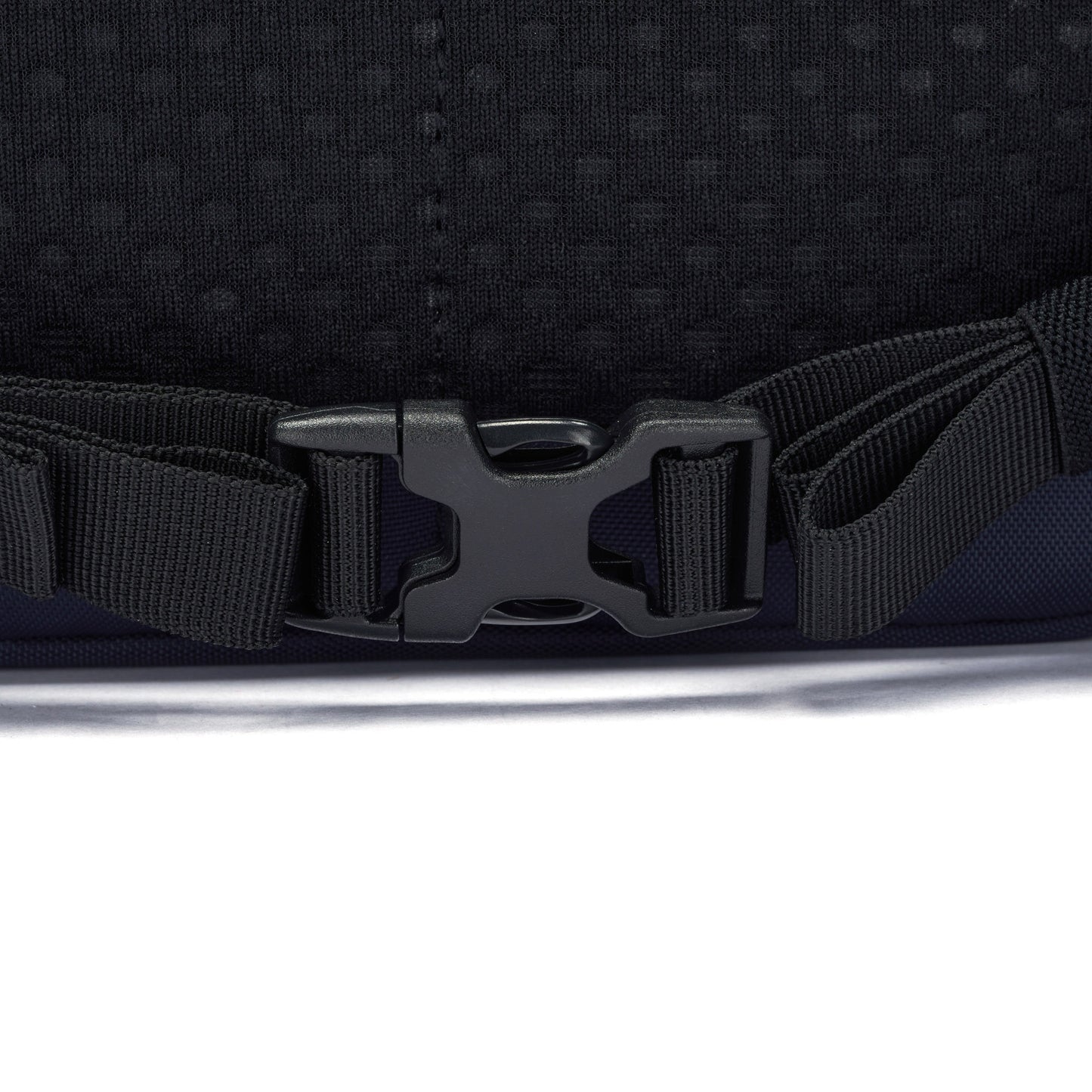 Close-up of a black buckle on a strap, clipped together on a Pacsafe® V 26L Anti-theft Tour Backpack.