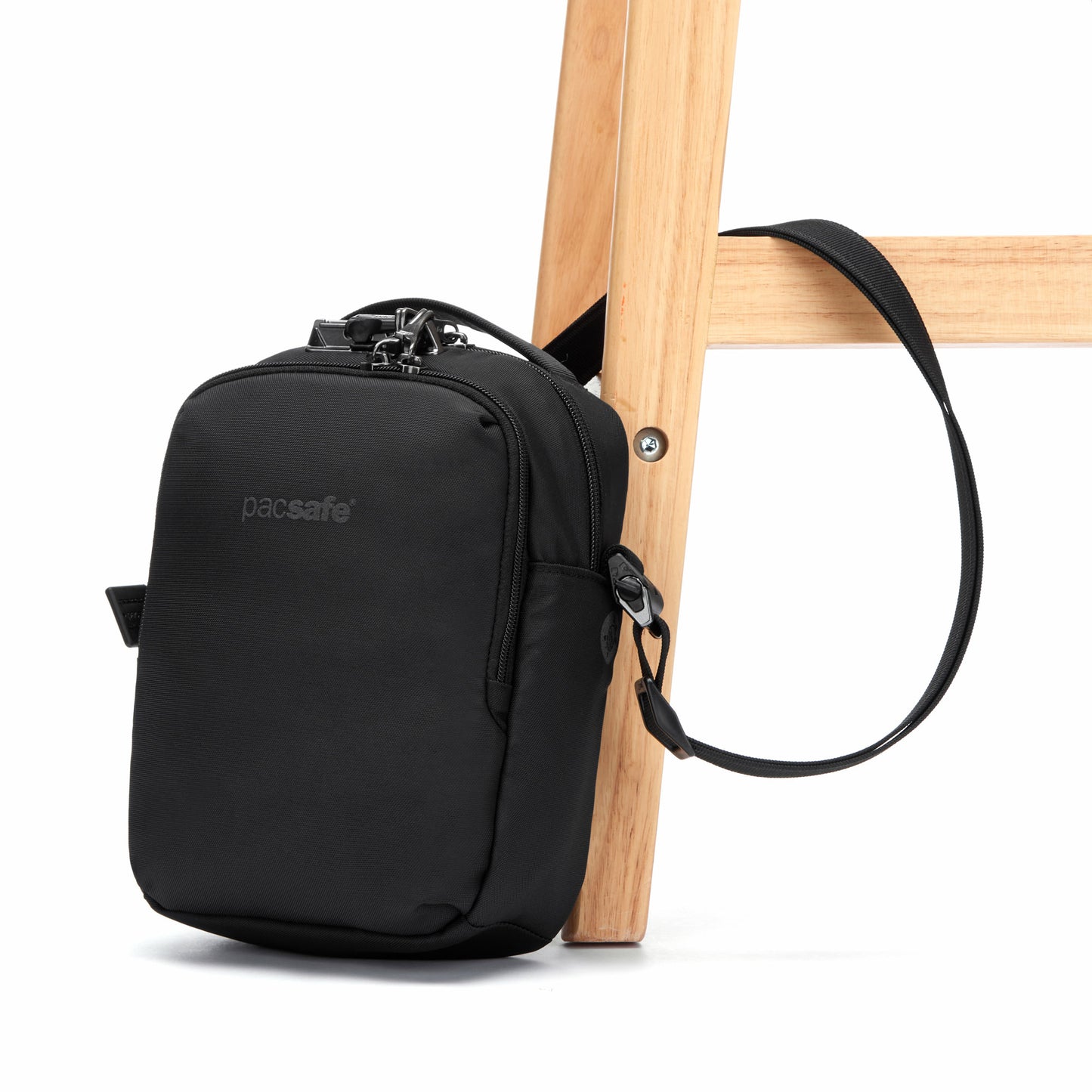 The Pacsafe® V Anti-theft Companion Crossbody is shown hanging from a wooden ladder.