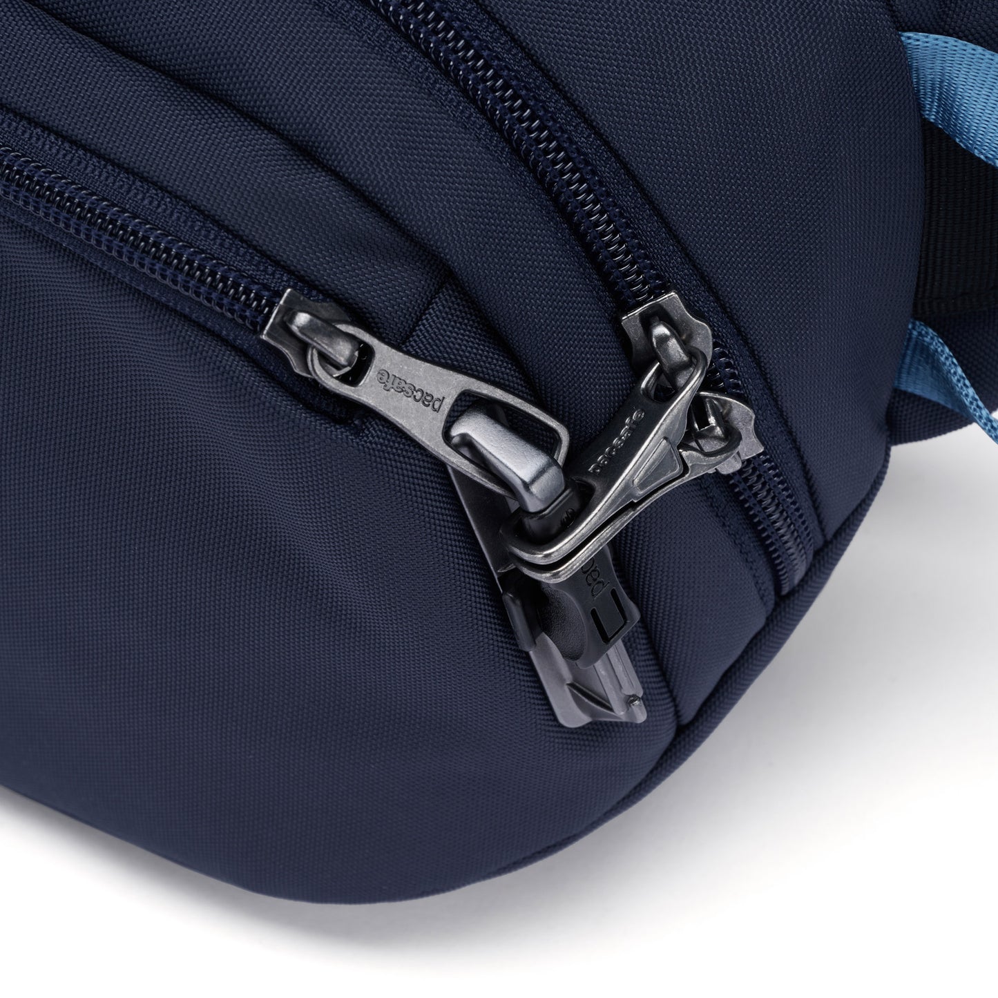 Close up of lockable zipper pulls on the Pacsafe® V anti-theft hip pack in ocean blue.