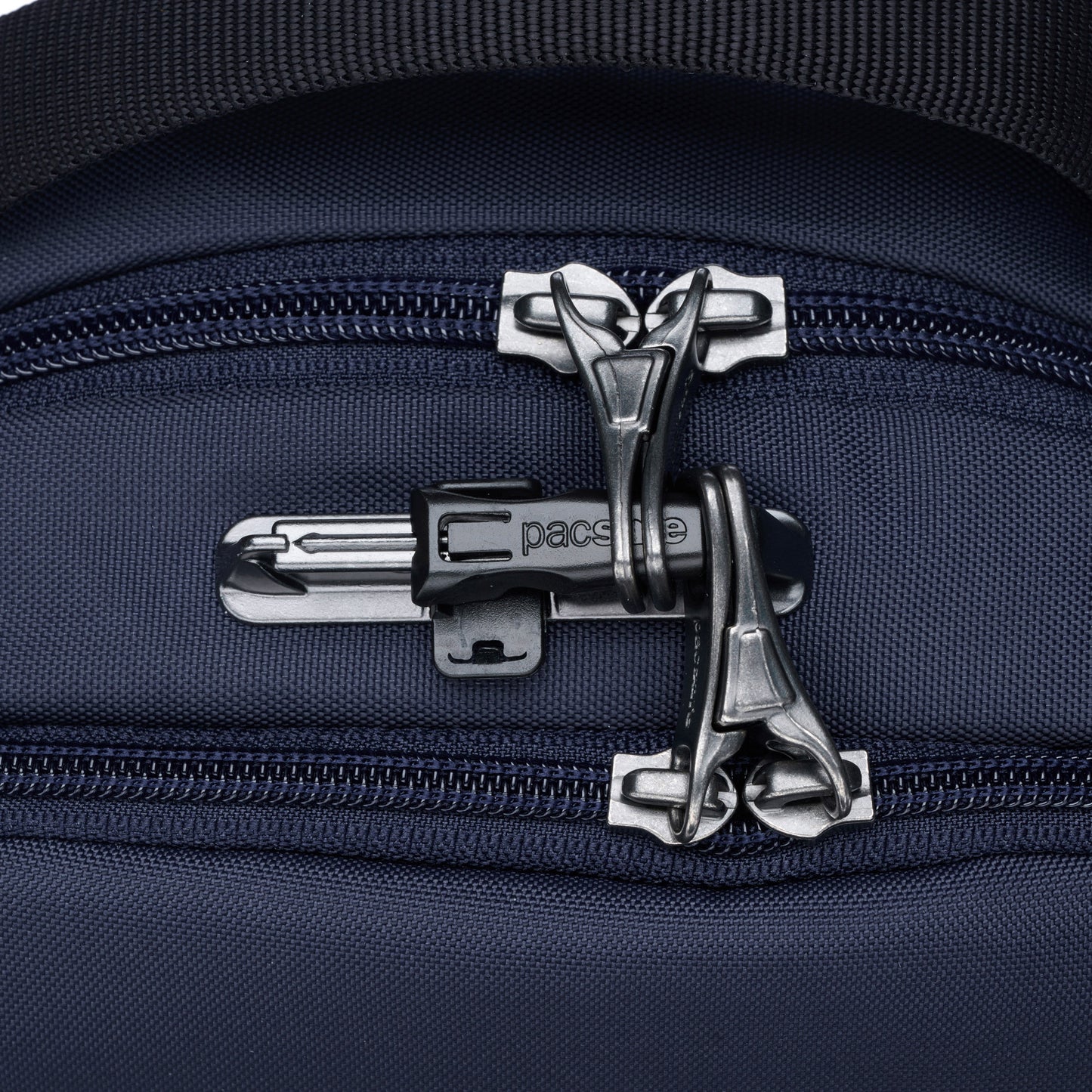 Close-up of the Pacsafe® V Anti-theft Tour Crossbody with lockable compartments & a silver security lock.