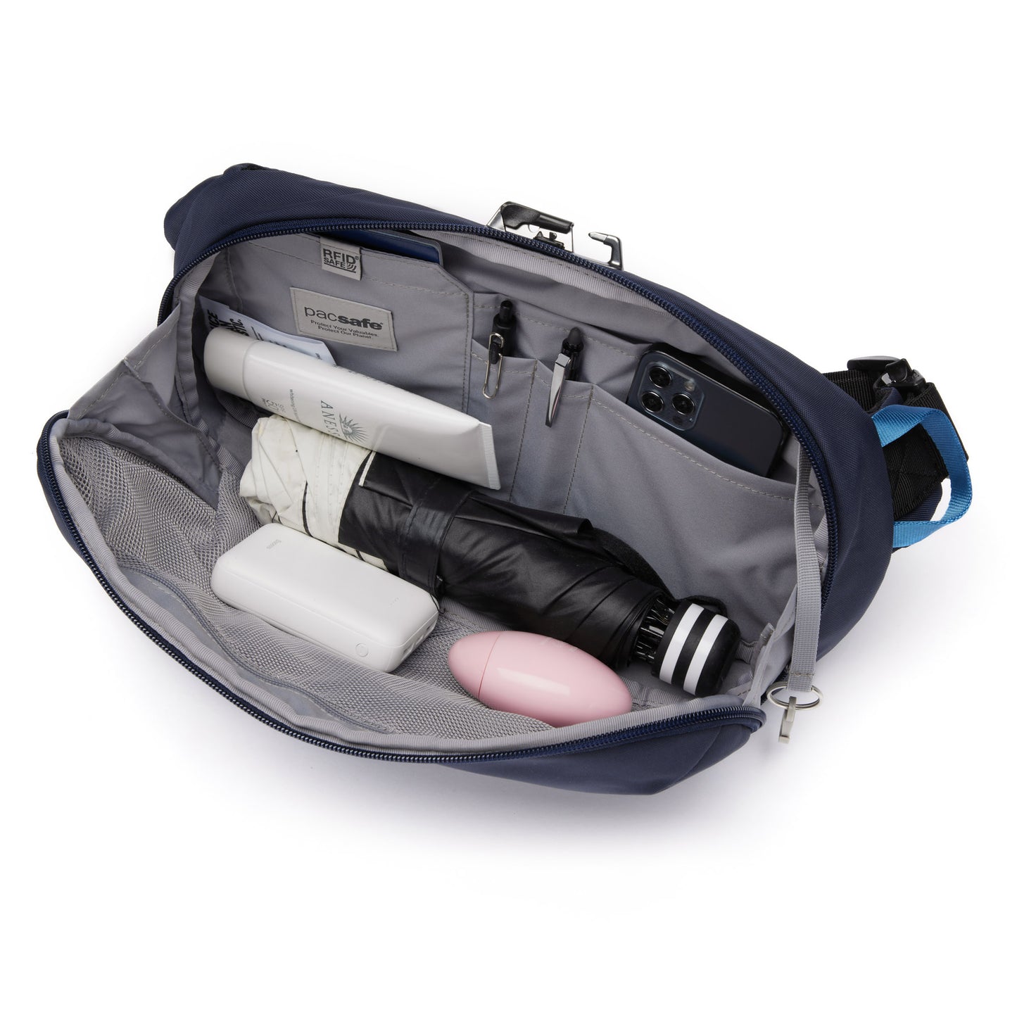 Inside the Pacsafe® V Anti-theft Urban Sling: water bottle, umbrella, phone, charger, pink bottle & container.
