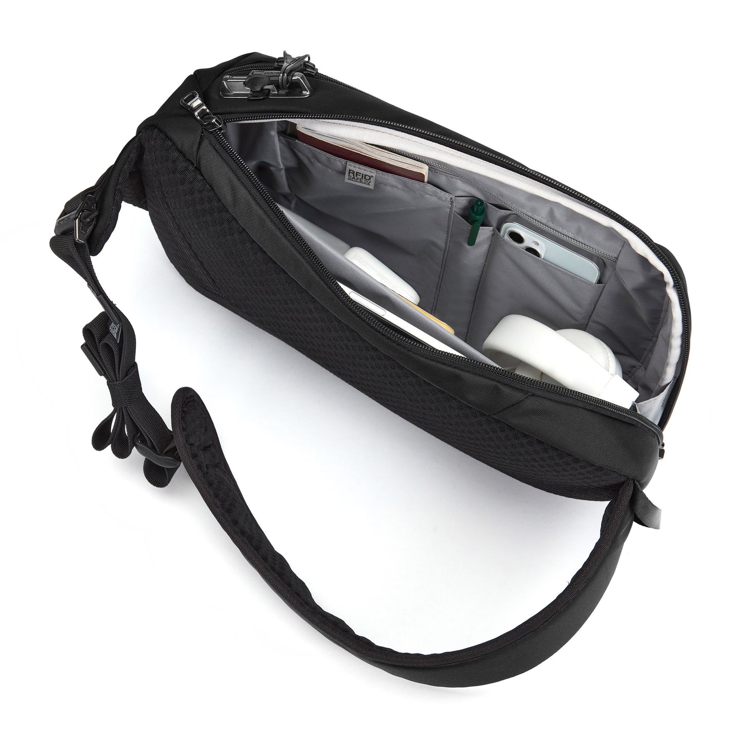 Open Pacsafe® V Tech Anti-theft Sling Pack in black, with organized compartments revealing items inside.